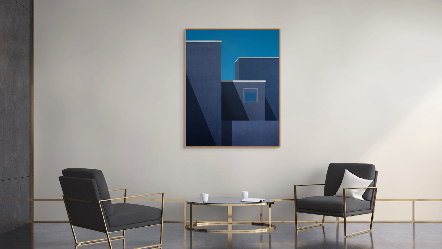 Modern interior with abstract blue artwork on a white wall, framed by two black chairs and a glass coffee table.