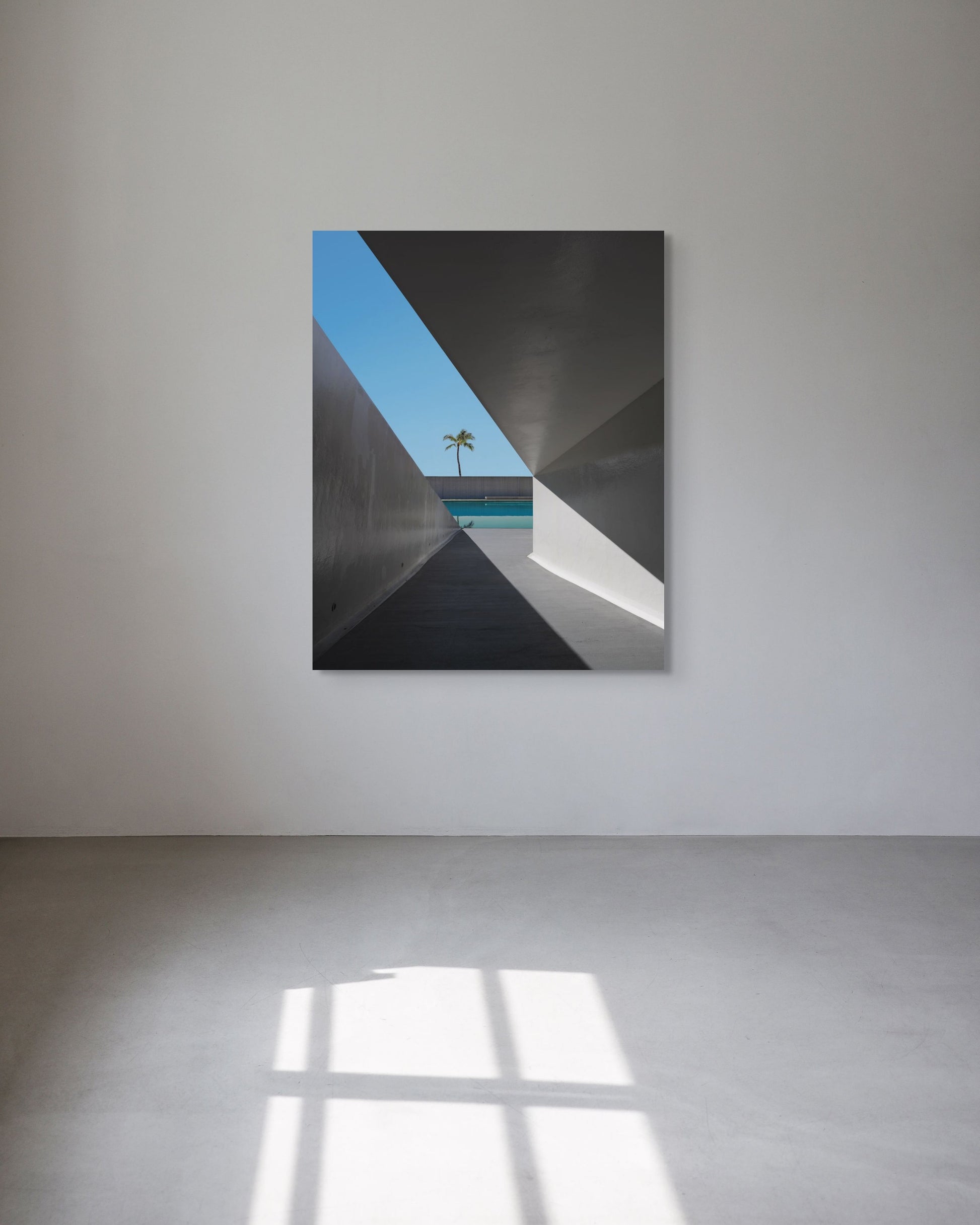 Architectural photography on a white sunlit wall.