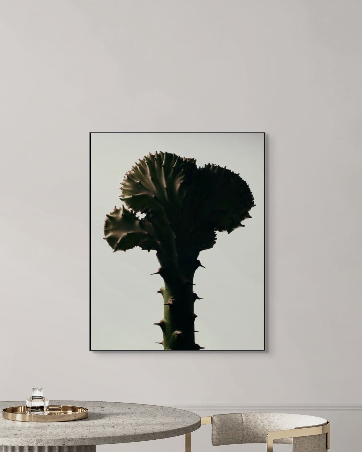 Framed artwork of a cactus on a wall in a modern interior setting.