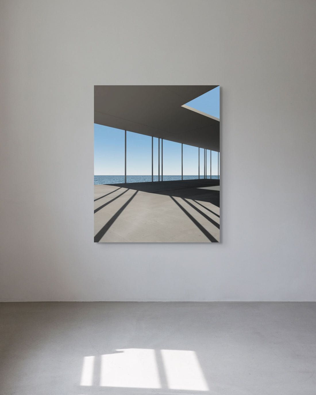 Modern architectural photograph of a building with large windows on a white wall.