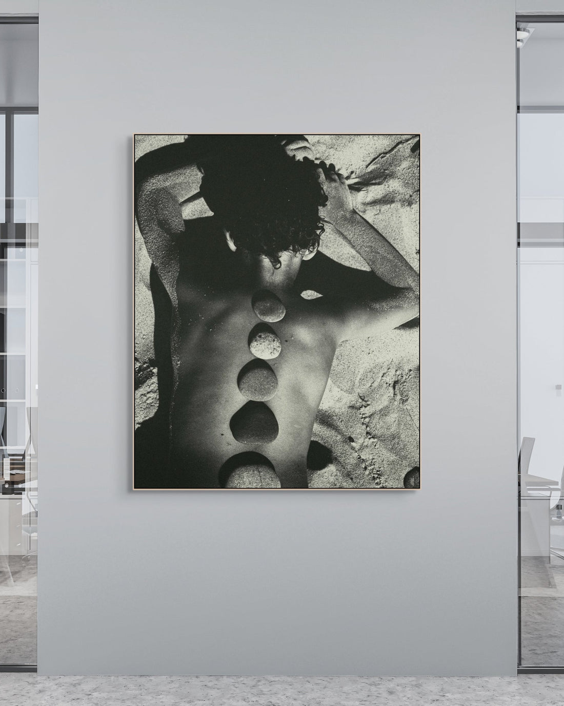 Modern office interior with a large black and white abstract print on a wall.