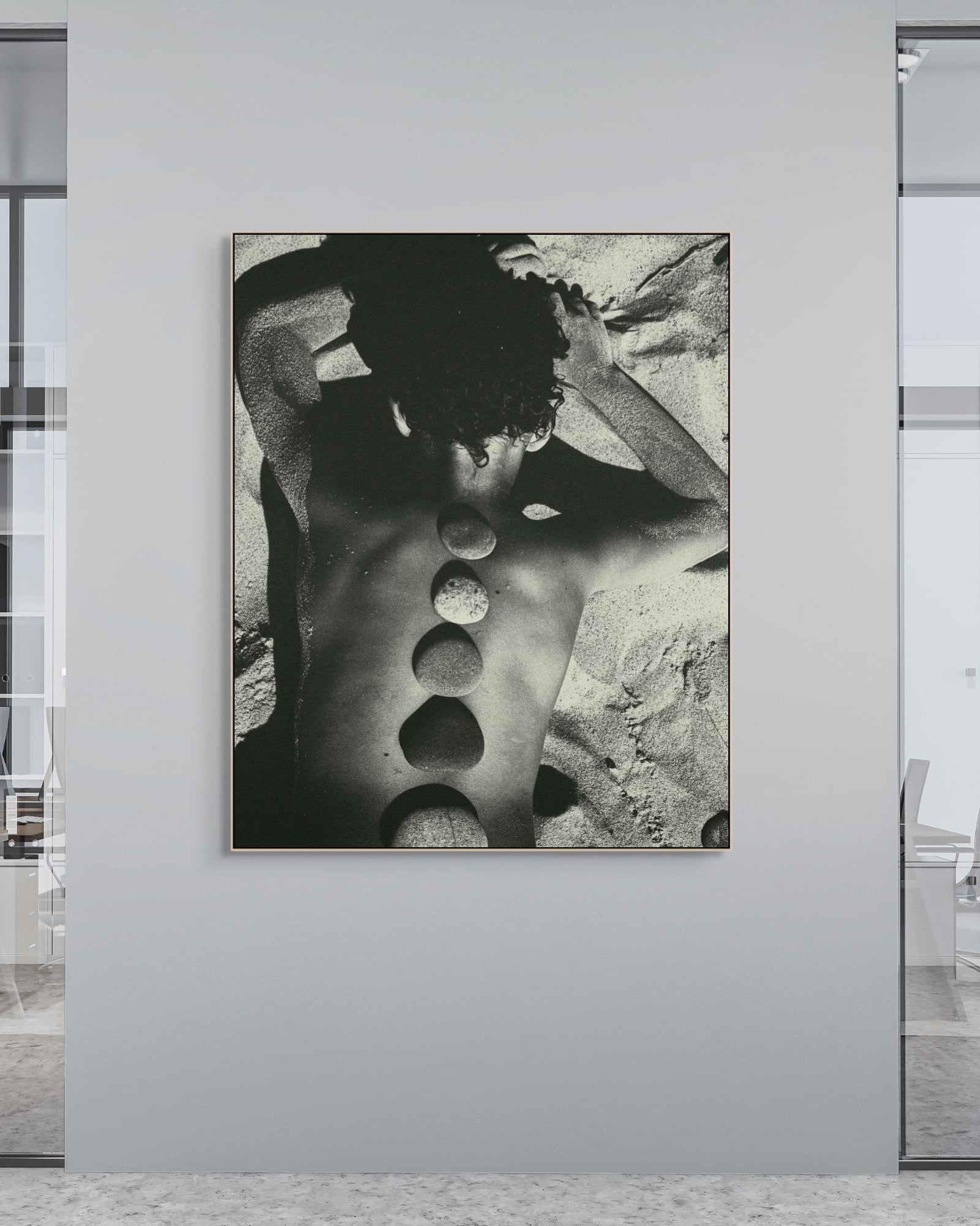 Modern office interior with a large black and white abstract print on a wall.