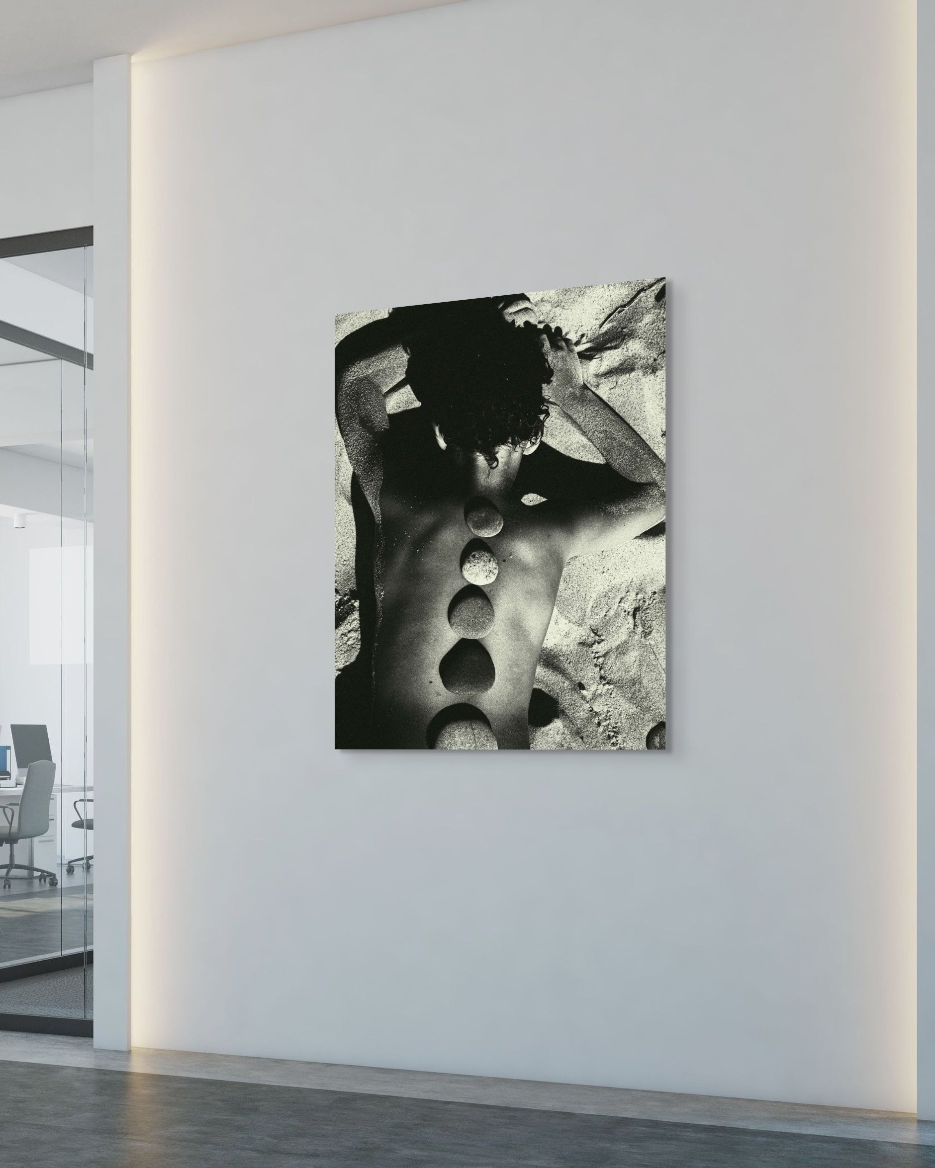 Abstract black and white artwork on a wall in a modern office setting