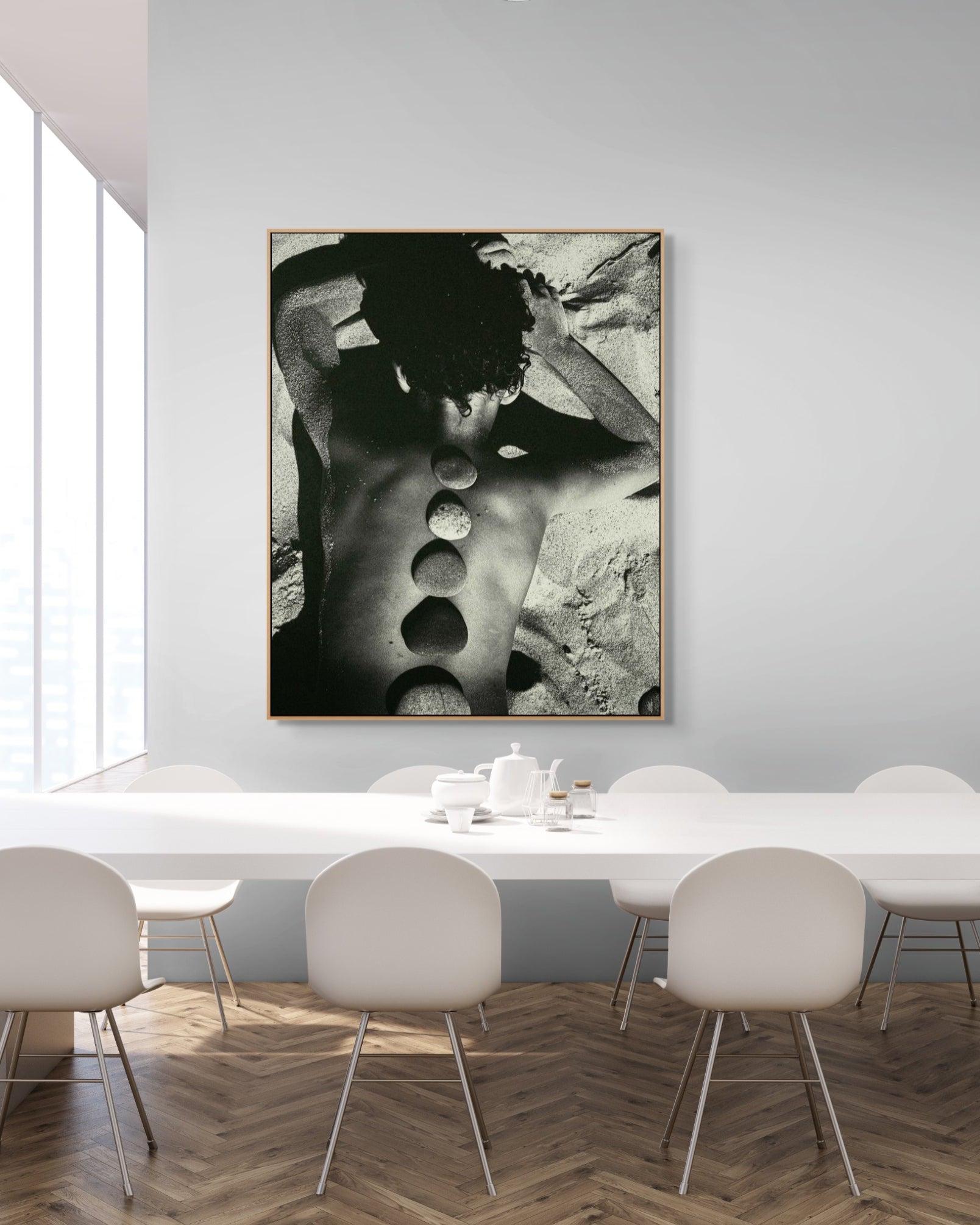Modern dining room with a large abstract photograph on the wall above a white table with chairs.