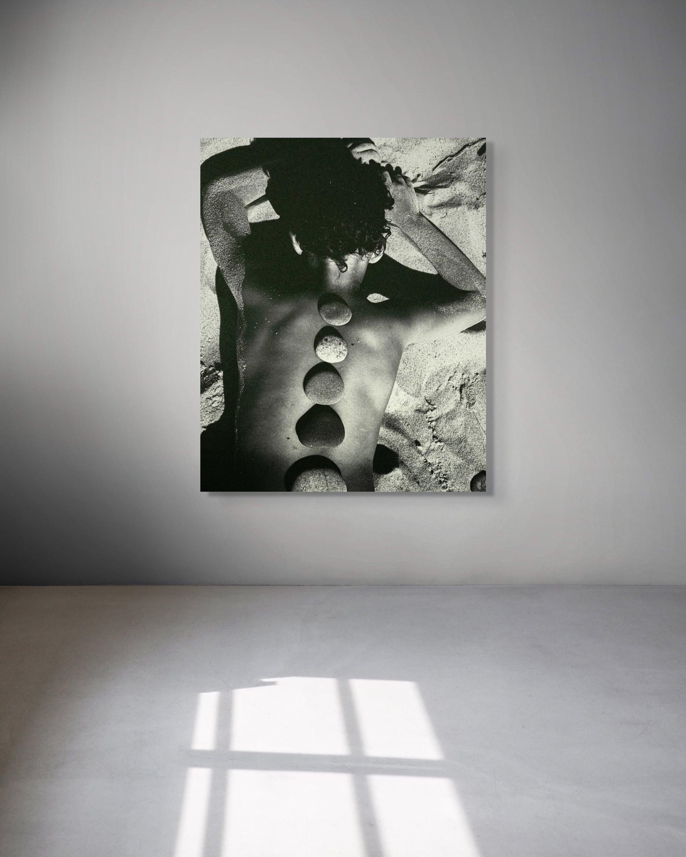 Black and white abstract art piece on a gray wall