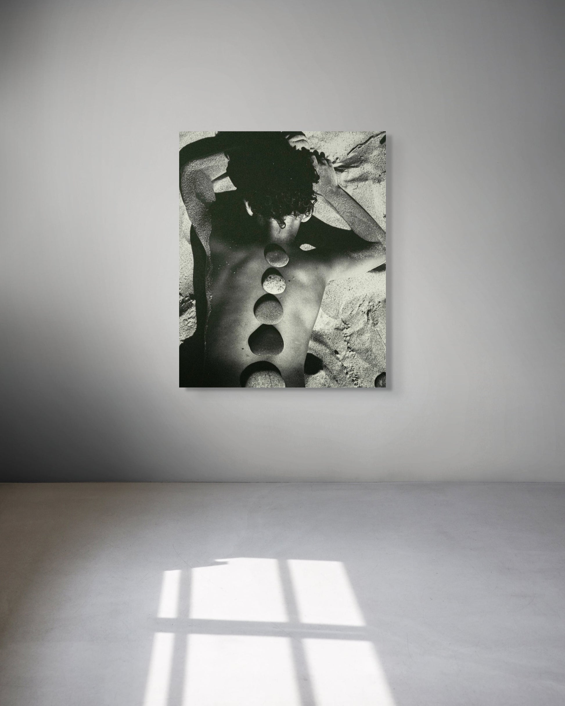 Framed black and white fine art print in minimalist space, Baltic Stones by Jonė Reed, ready to hang metal print