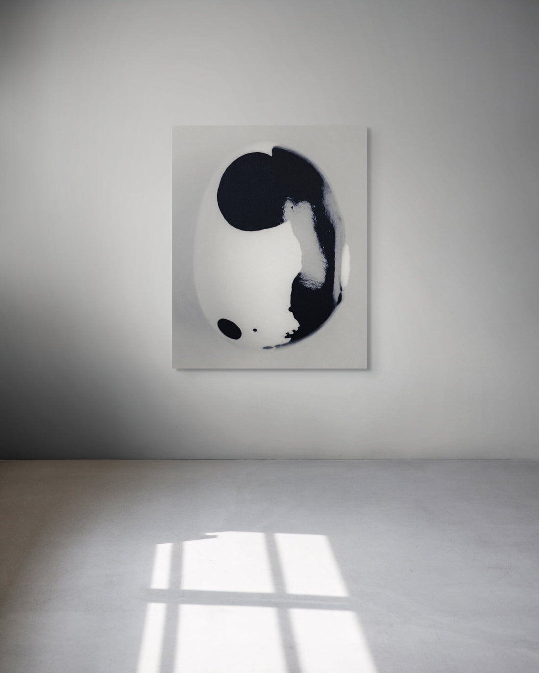 Abstract black and white metal print on a white wall.