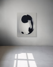 Abstract black and white metal print on a white wall.