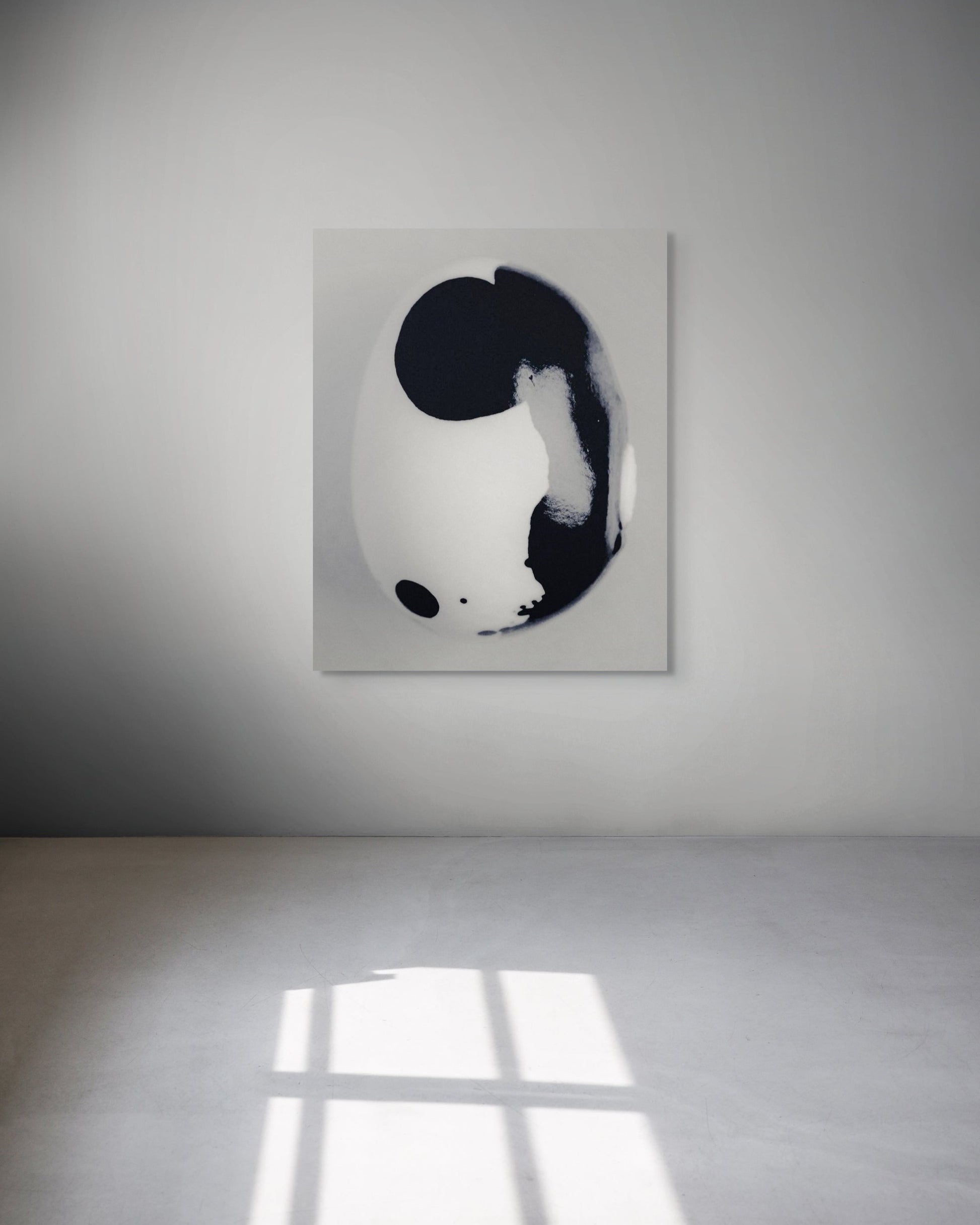 Abstract black and white metal print on a white wall.