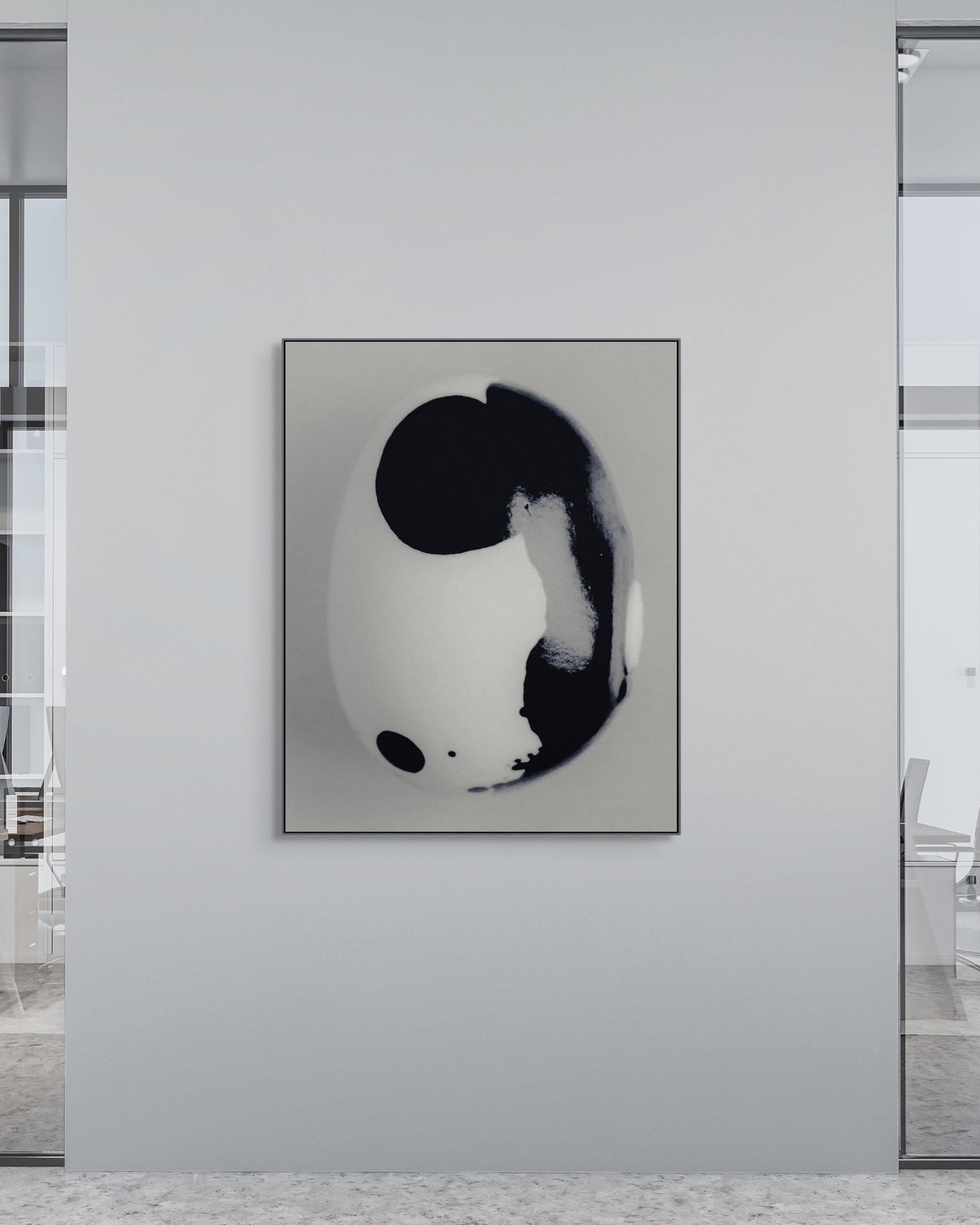 Modern office interior with a black and white abstract photograph on a wall.
