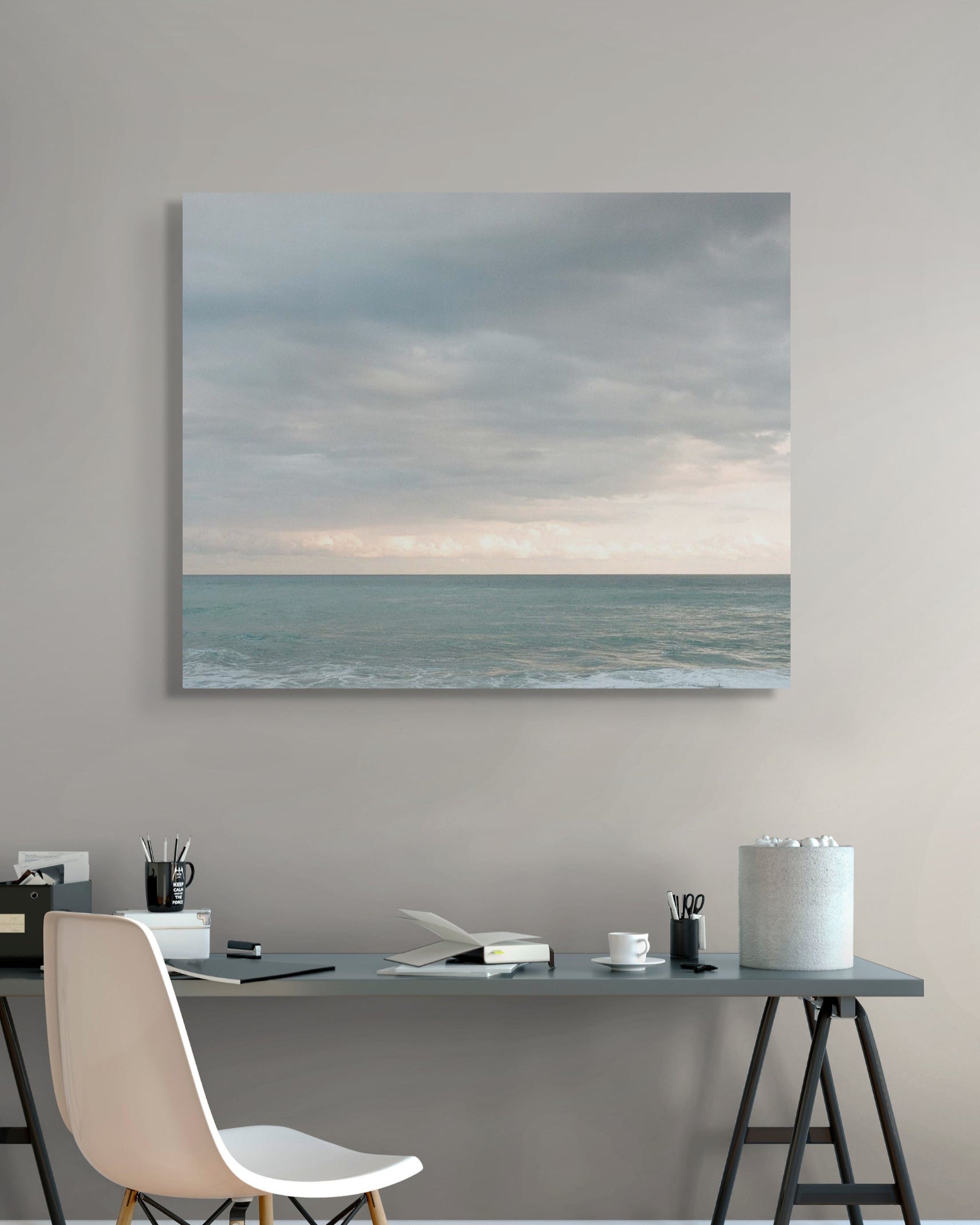 Seascape photograph by Mark Forbes displayed above a modern home office desk with neutral tones and minimalist decor.