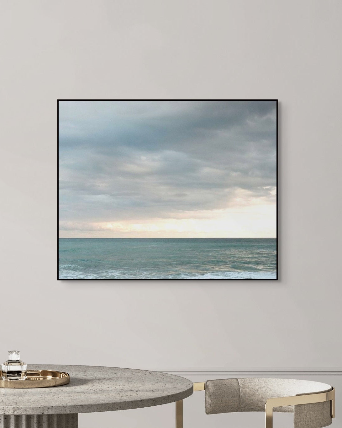 Modern interior with a large wall art of an ocean scene.