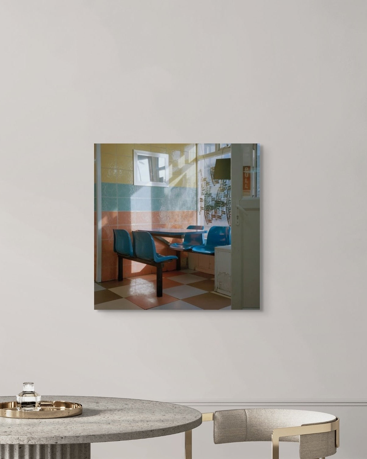 Modern interior with a round marble table and metal wall art.