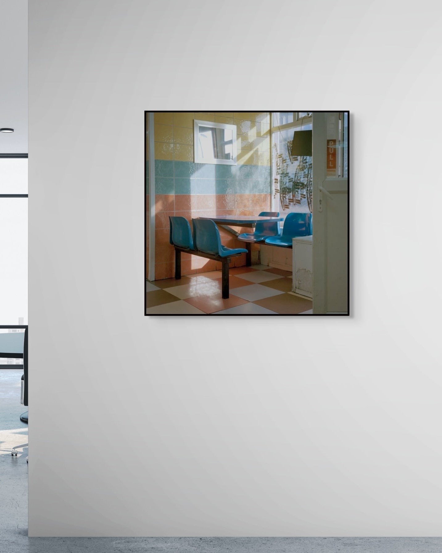 Framed artwork on a wall in an office setting