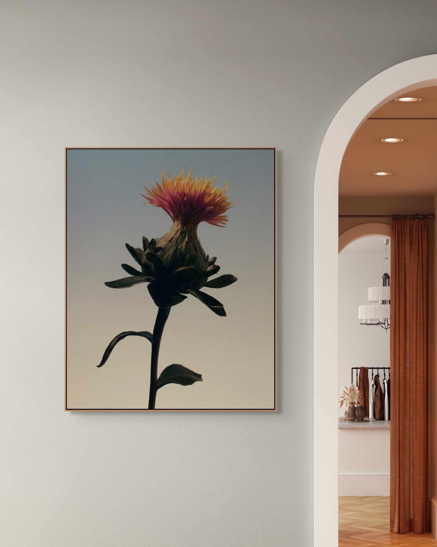 Framed artwork of a flower on a wall with a room in the background