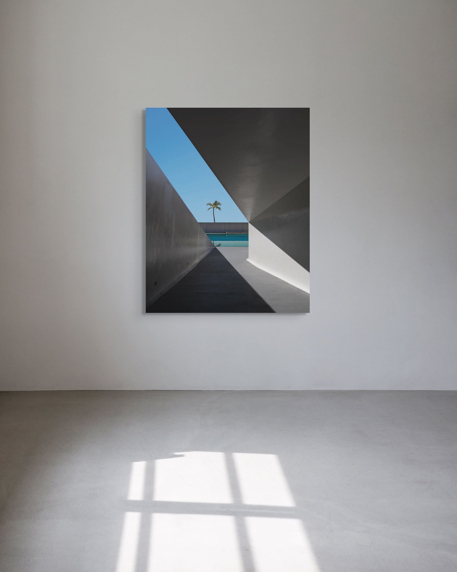 Abstract metal print with geometric shapes on a white wall