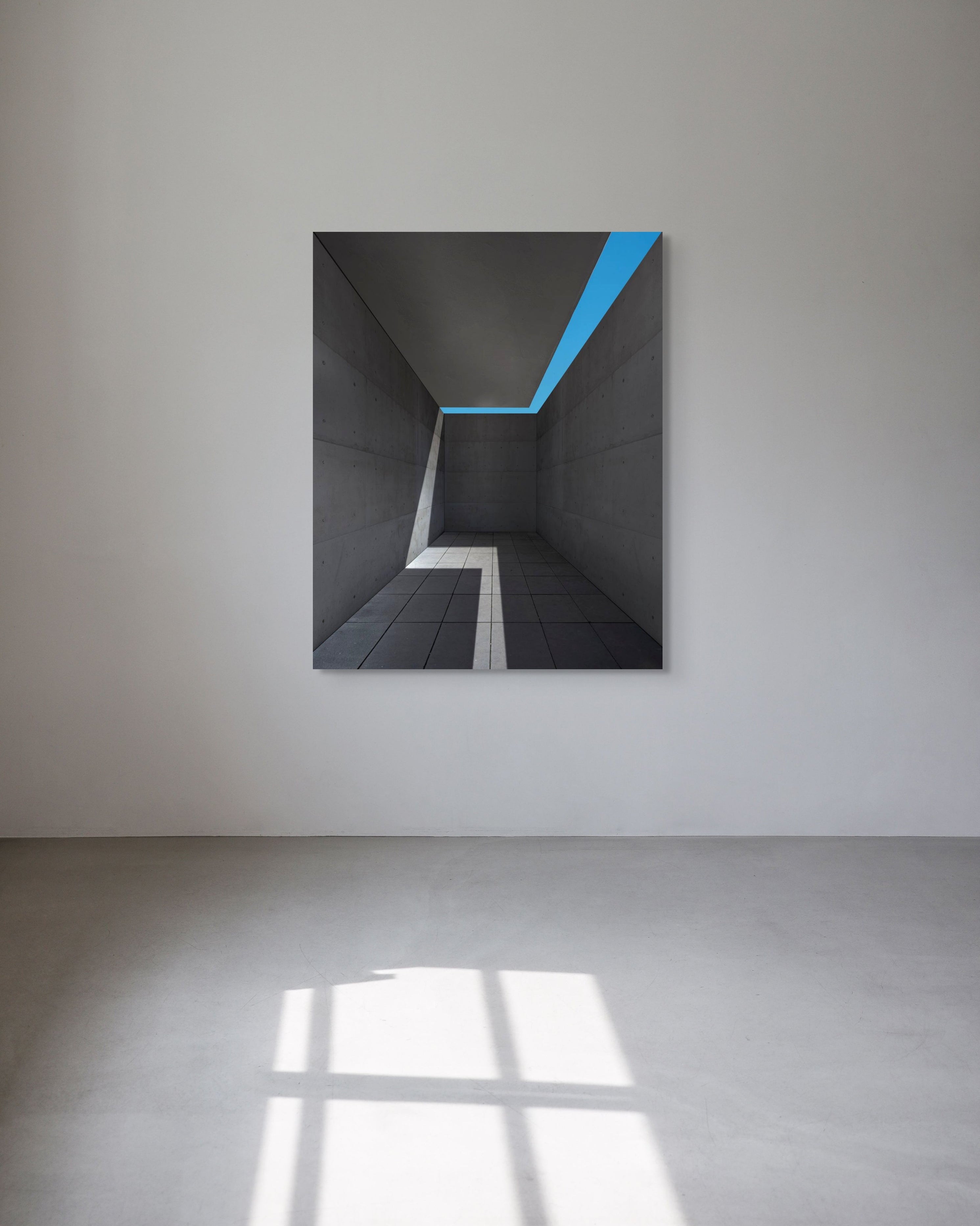 Abstract artwork with a blue diagonal stripe on a white wall