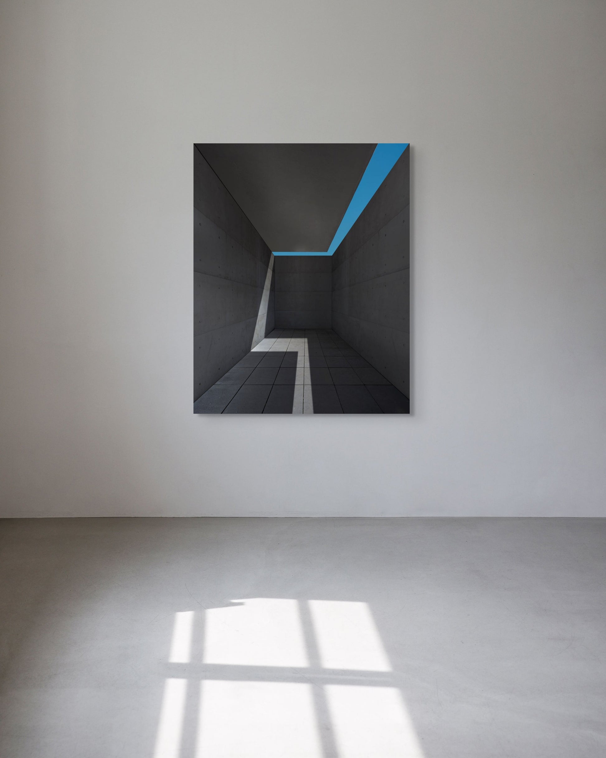 Abstract artwork with a blue stripe on a white wall