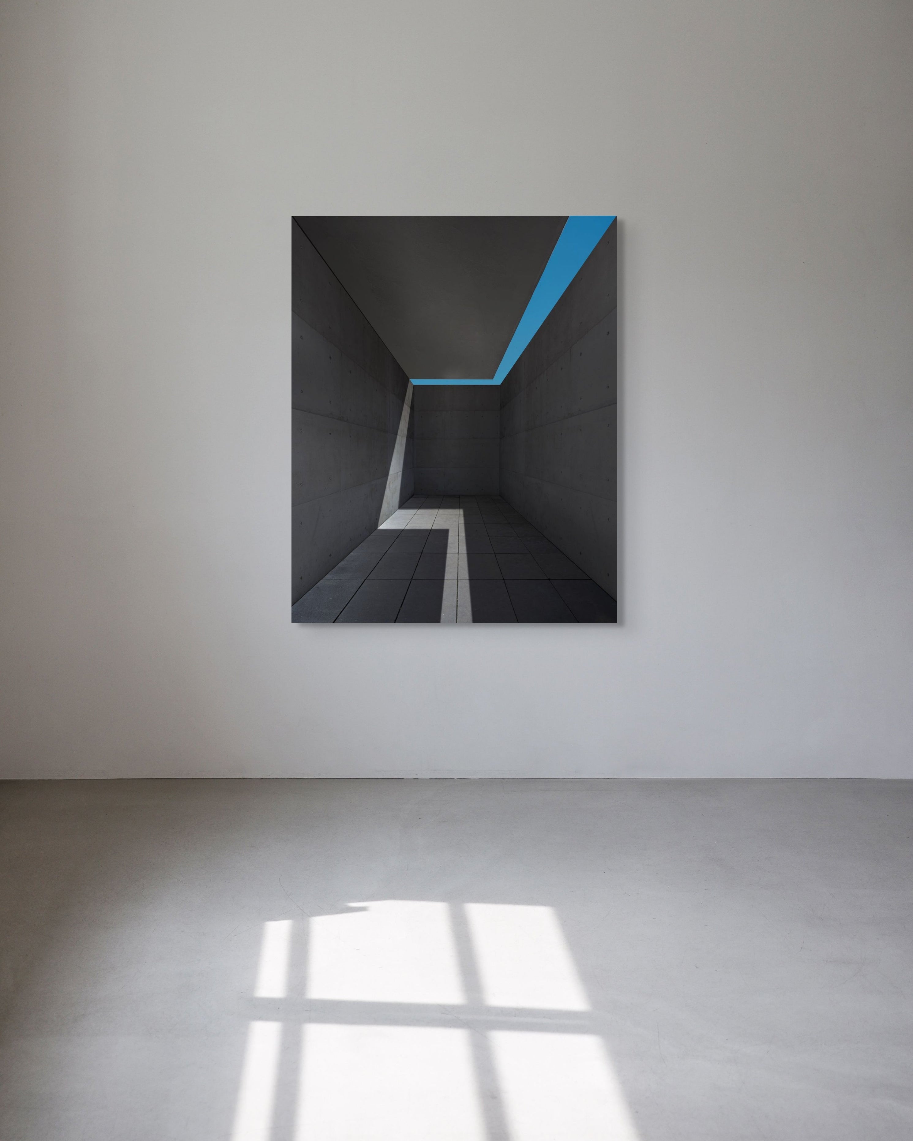 Abstract artwork with a blue stripe on a white wall