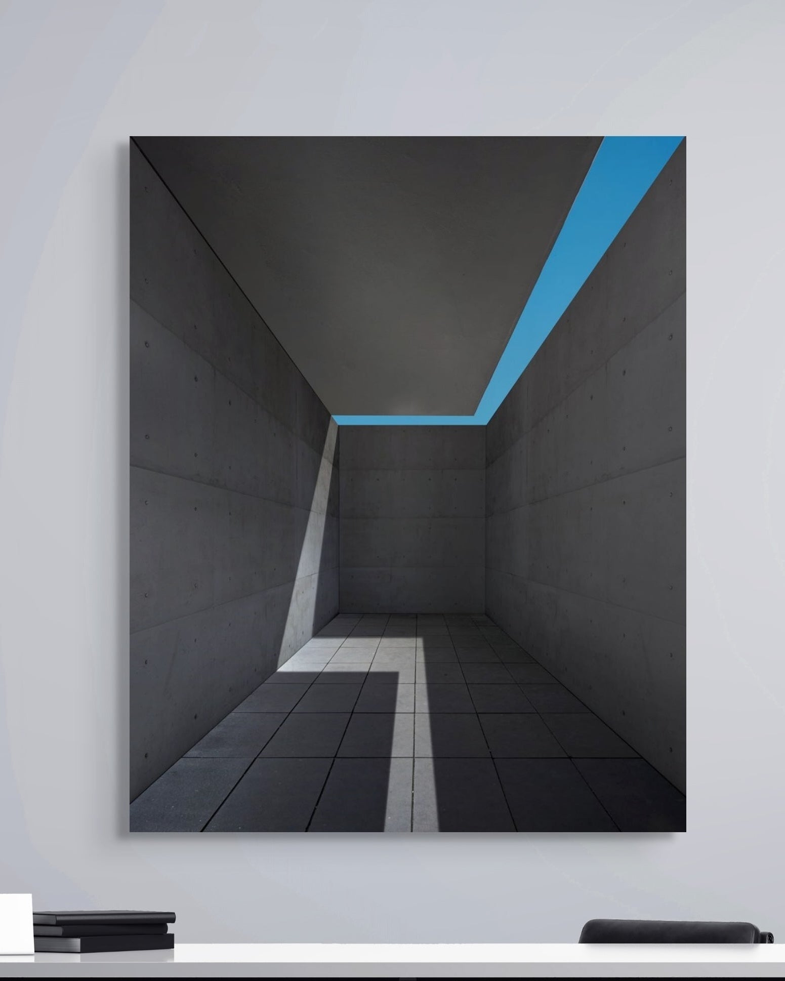 Modern interior design with a black and blue abstract painting on a white wall.