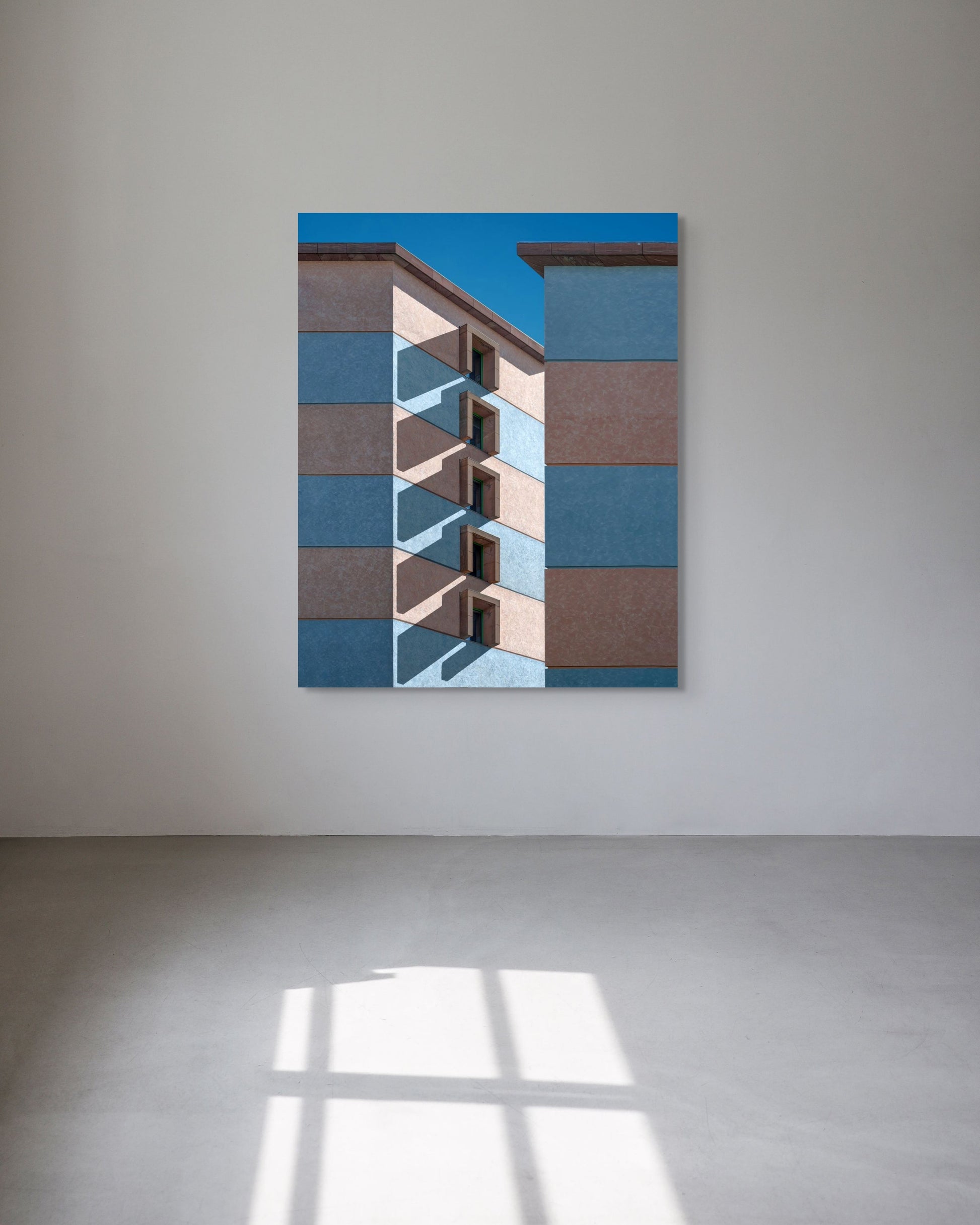 Abstract art piece on a white wall with geometric patterns.