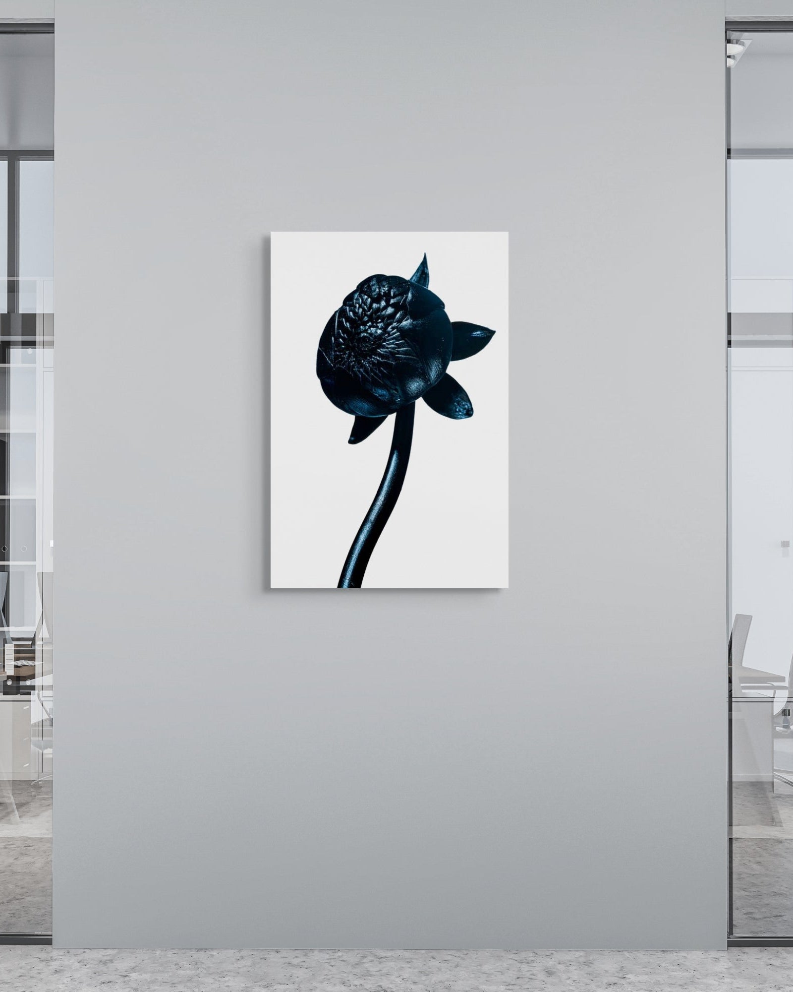 Modern office setting with a black and white abstract painting on a gray wall.