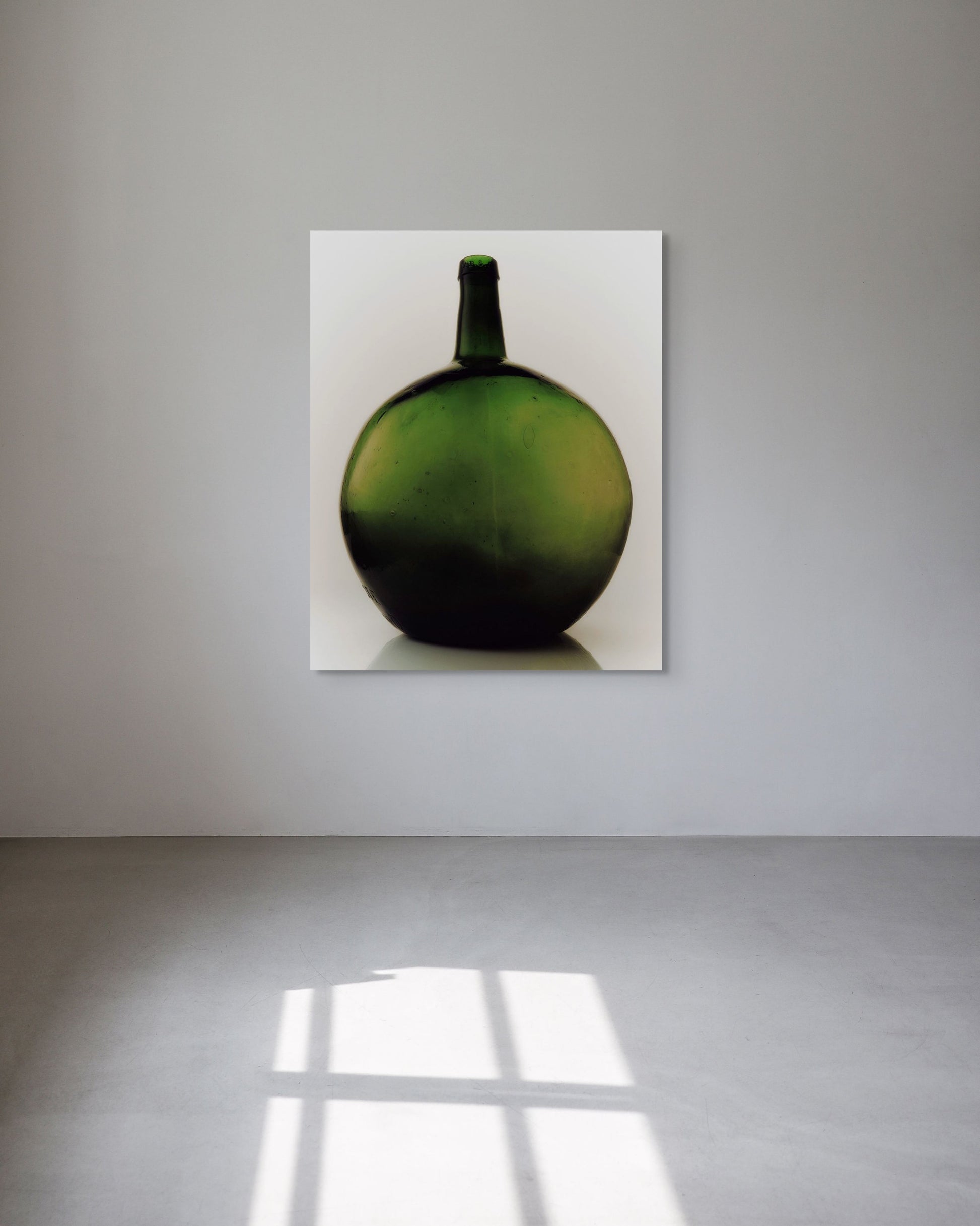 Green bottle-like metal print on a white background