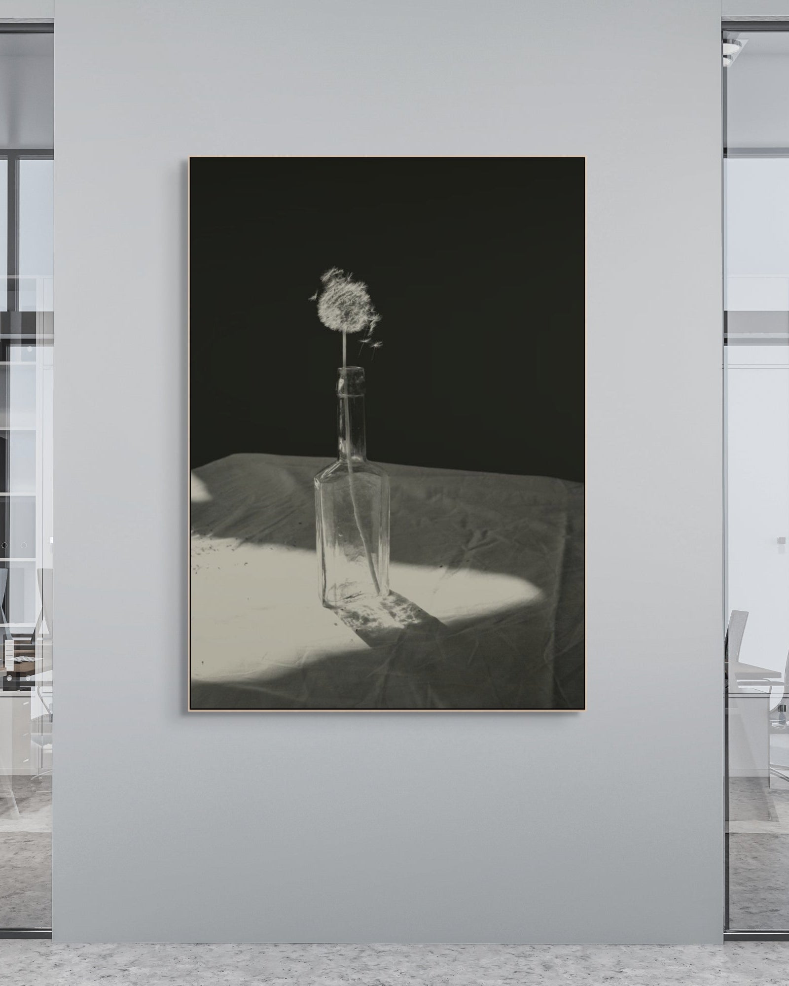 Modern office interior with a framed black and white photograph on the wall.