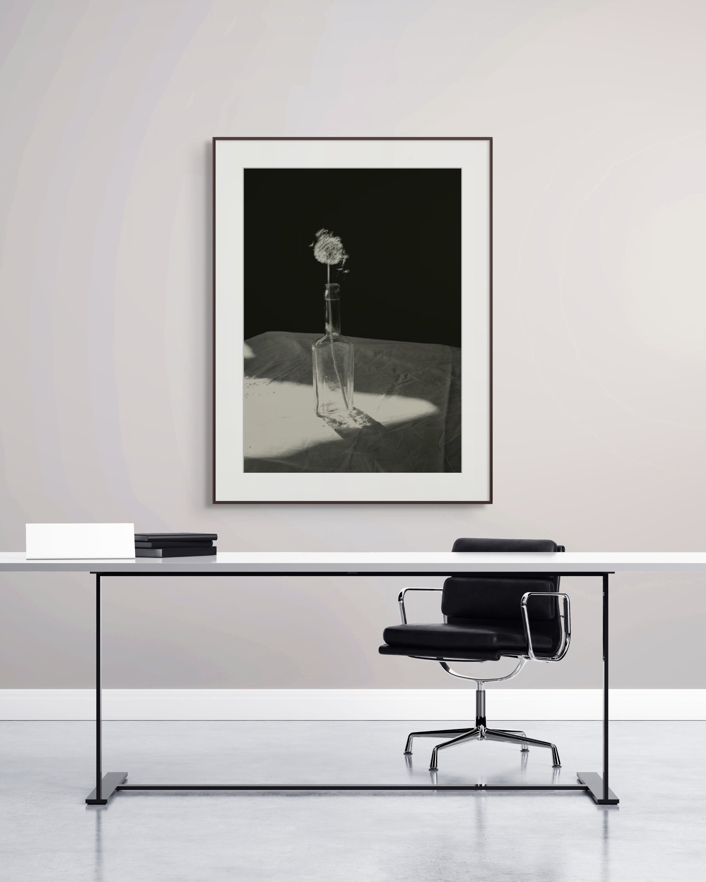 Dandelion by Jonė Reed – Black and white limited edition fine art photograph, archival-quality print hanging in modern office setup with a desk and chair.