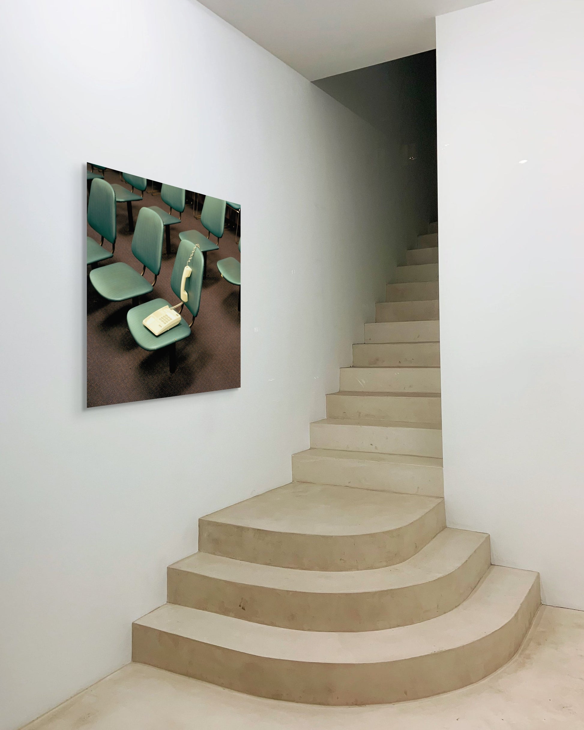 Staircase with a wall-mounted abstract art piece depicting chairs.