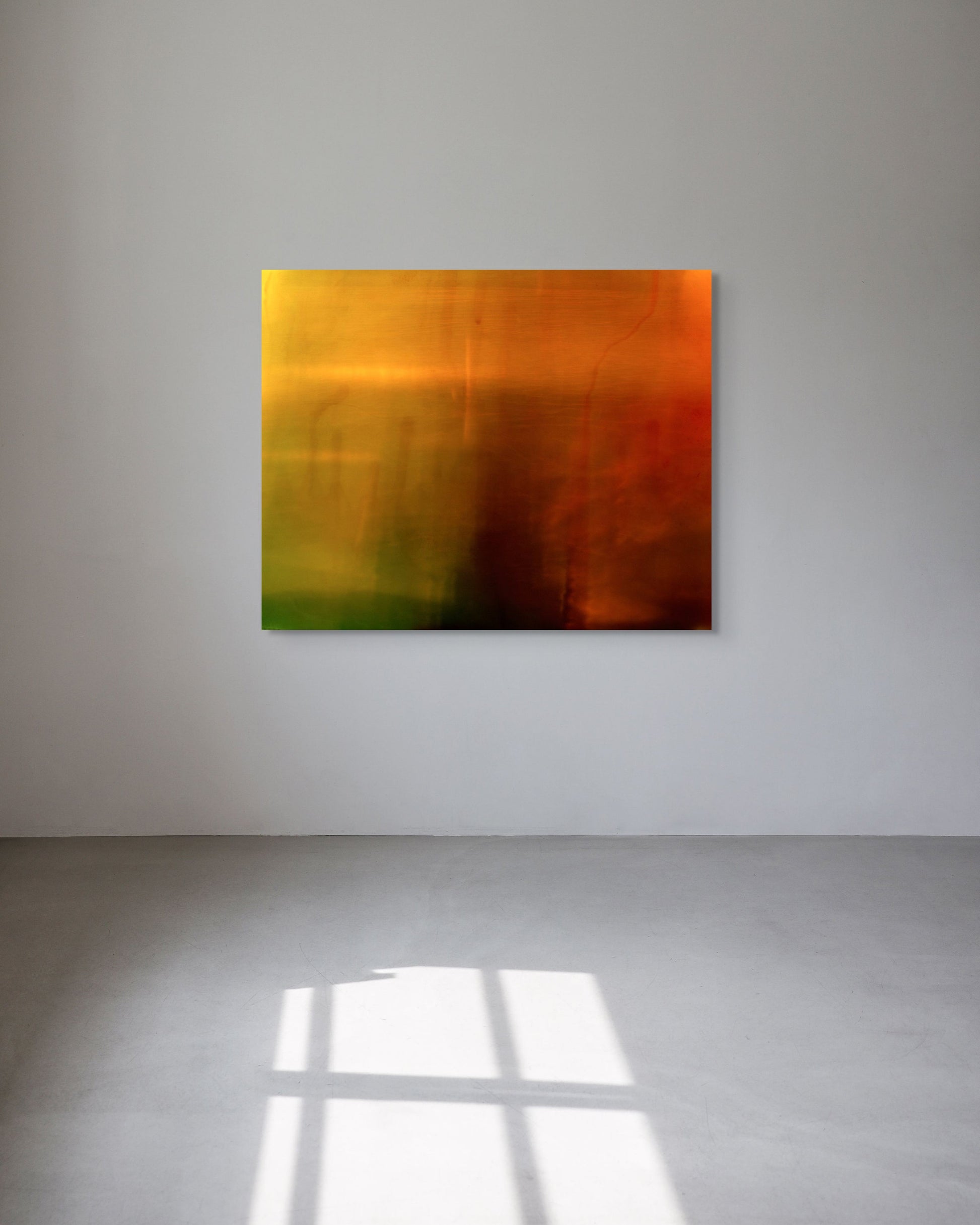 Abstract metal print on a white wall with a reflective floor.