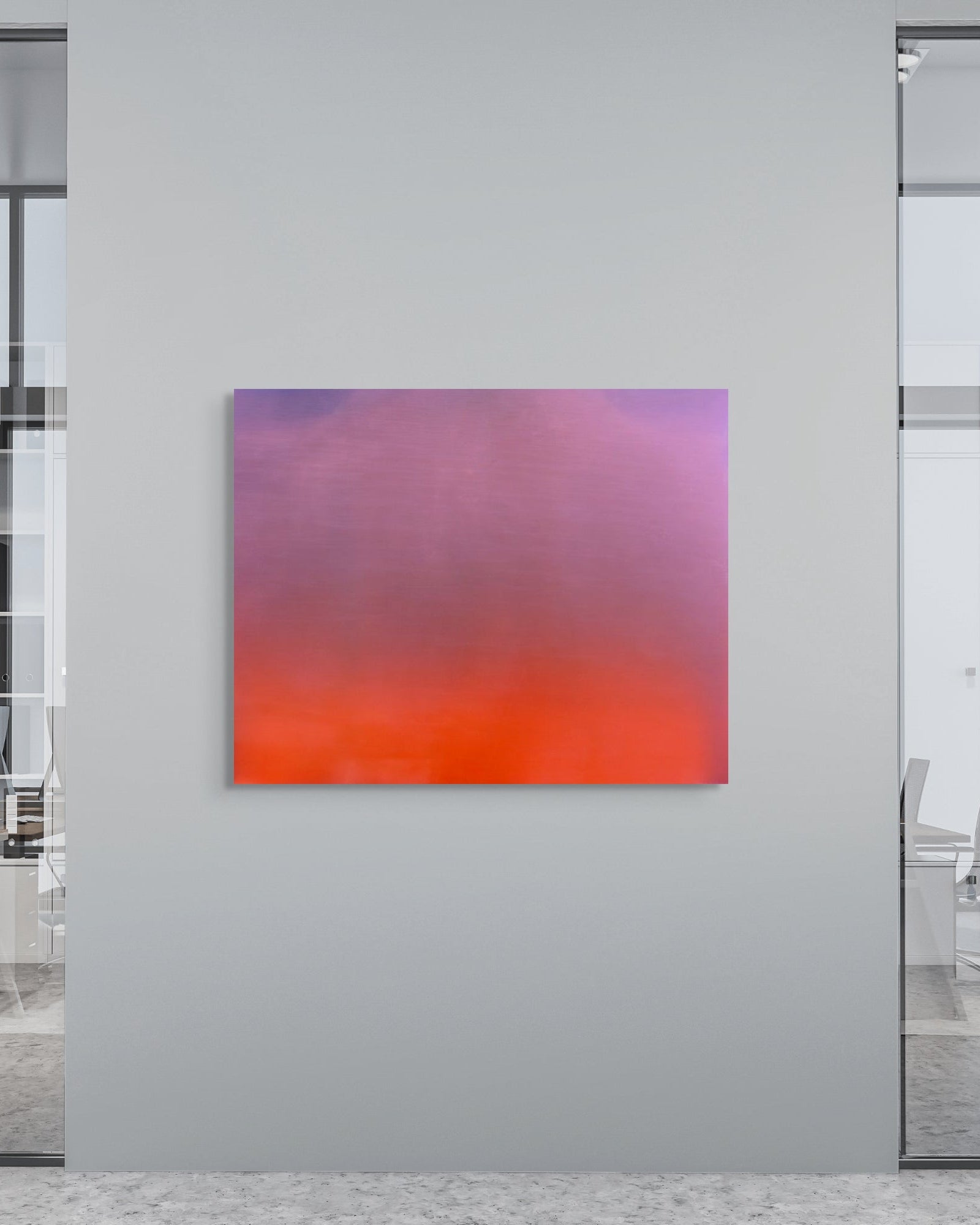 Modern office interior with a colorful abstract metal print on a gray wall.