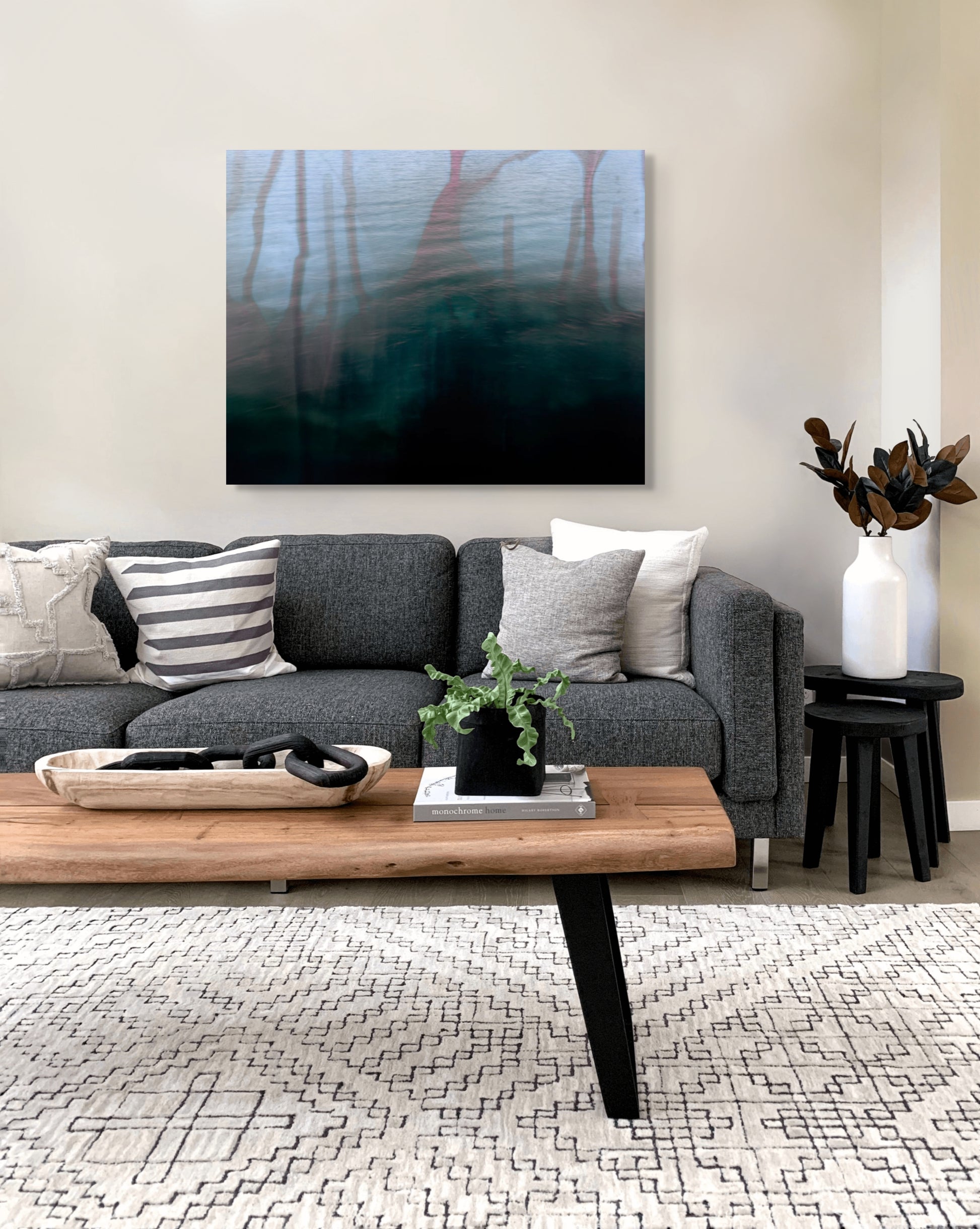 Metal print Dithering III by Marcus Reistad displayed above a modern sofa in a warm, neutral living room.