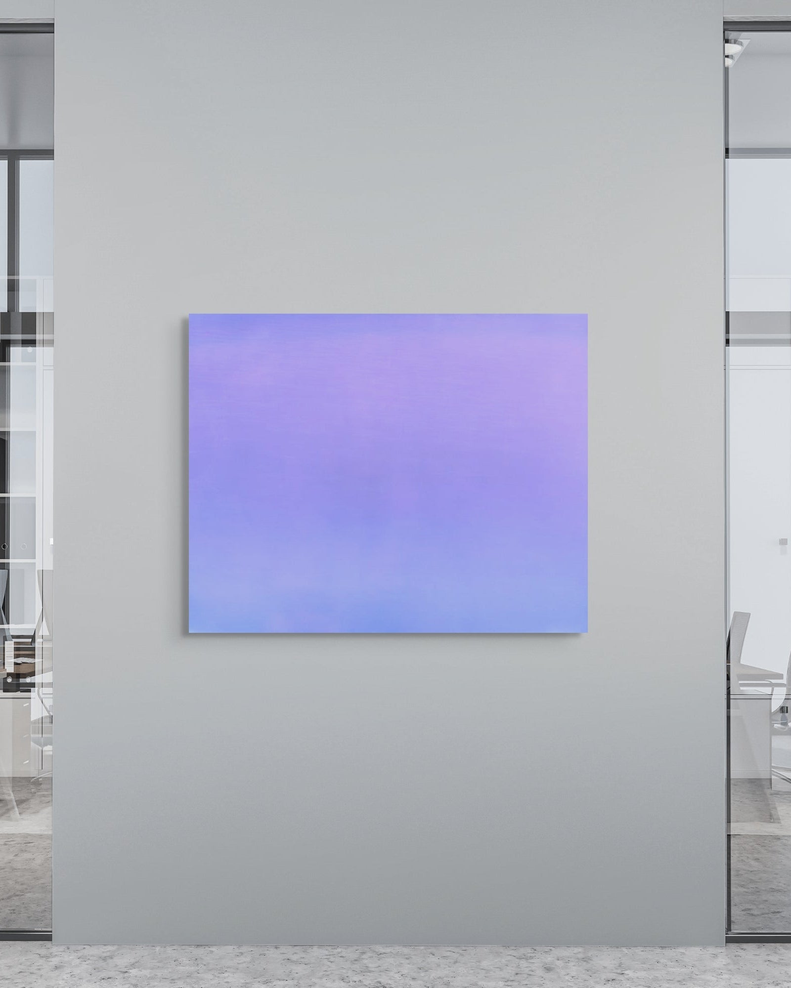 Modern office interior with an abstract metal print on a wall.