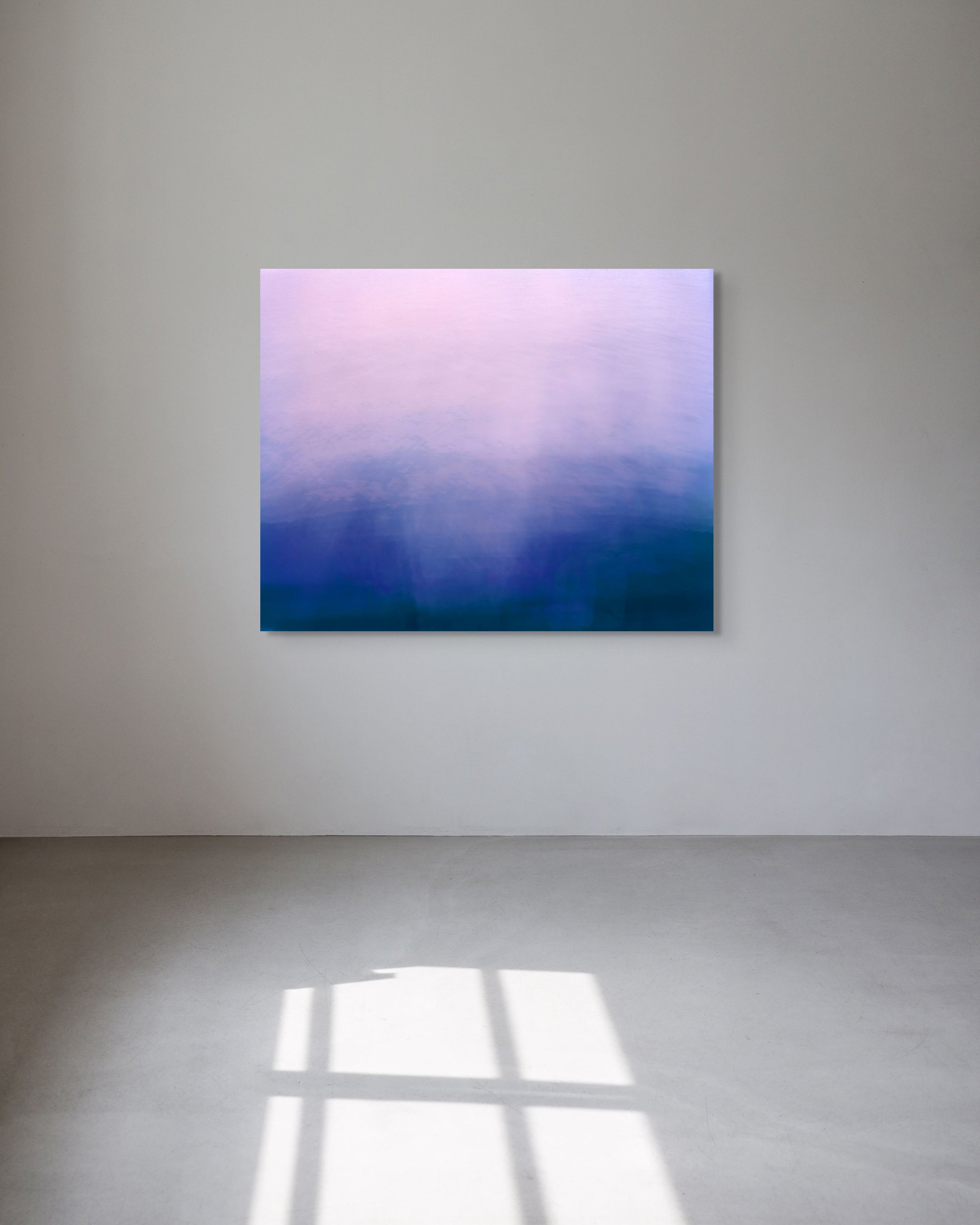 Abstract metal print with a gradient from purple to blue on a white wall.