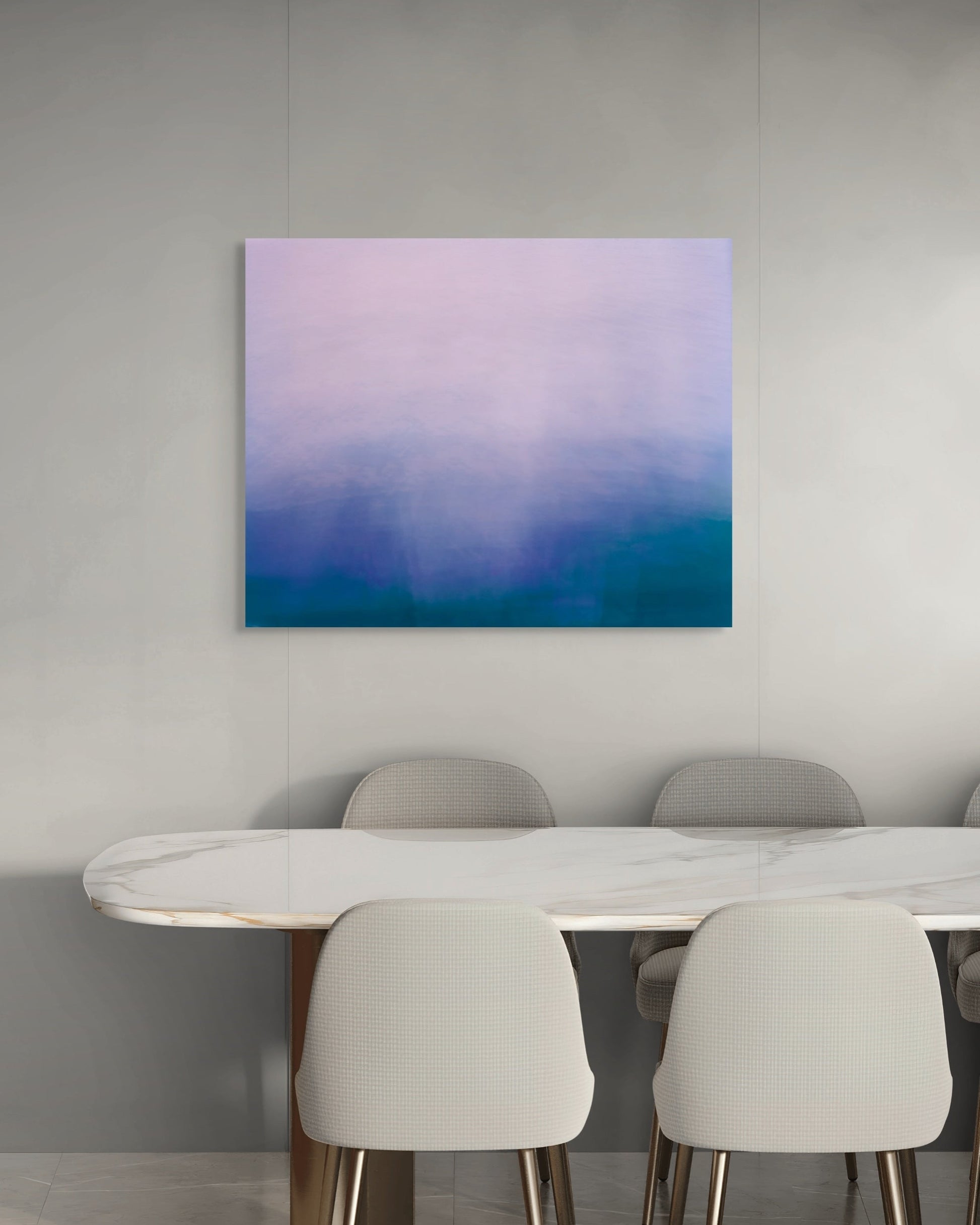 Abstract print with a gradient from purple to blue above a dining table and chairs.