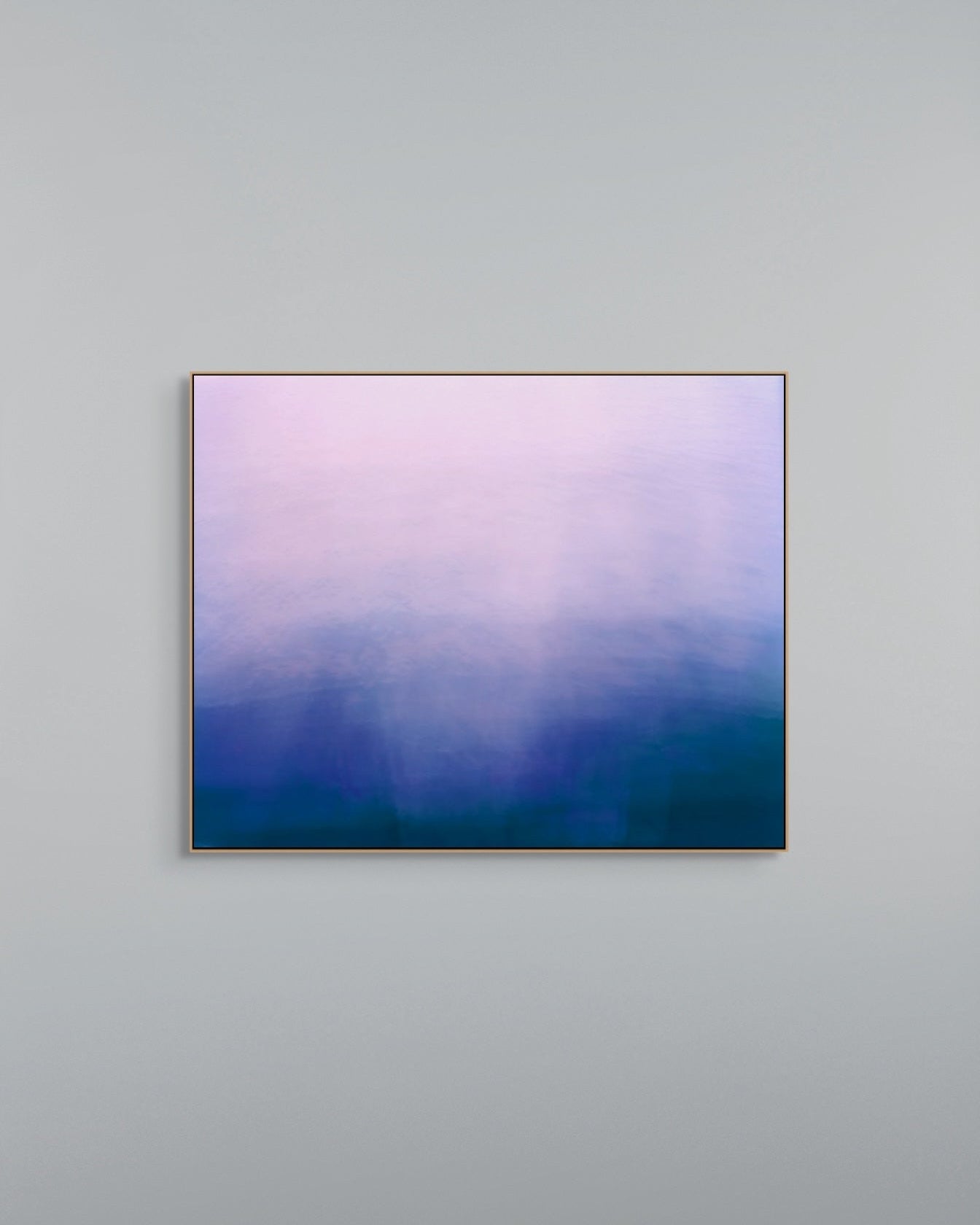 Framed artwork with a gradient of purple and blue on a gray wall