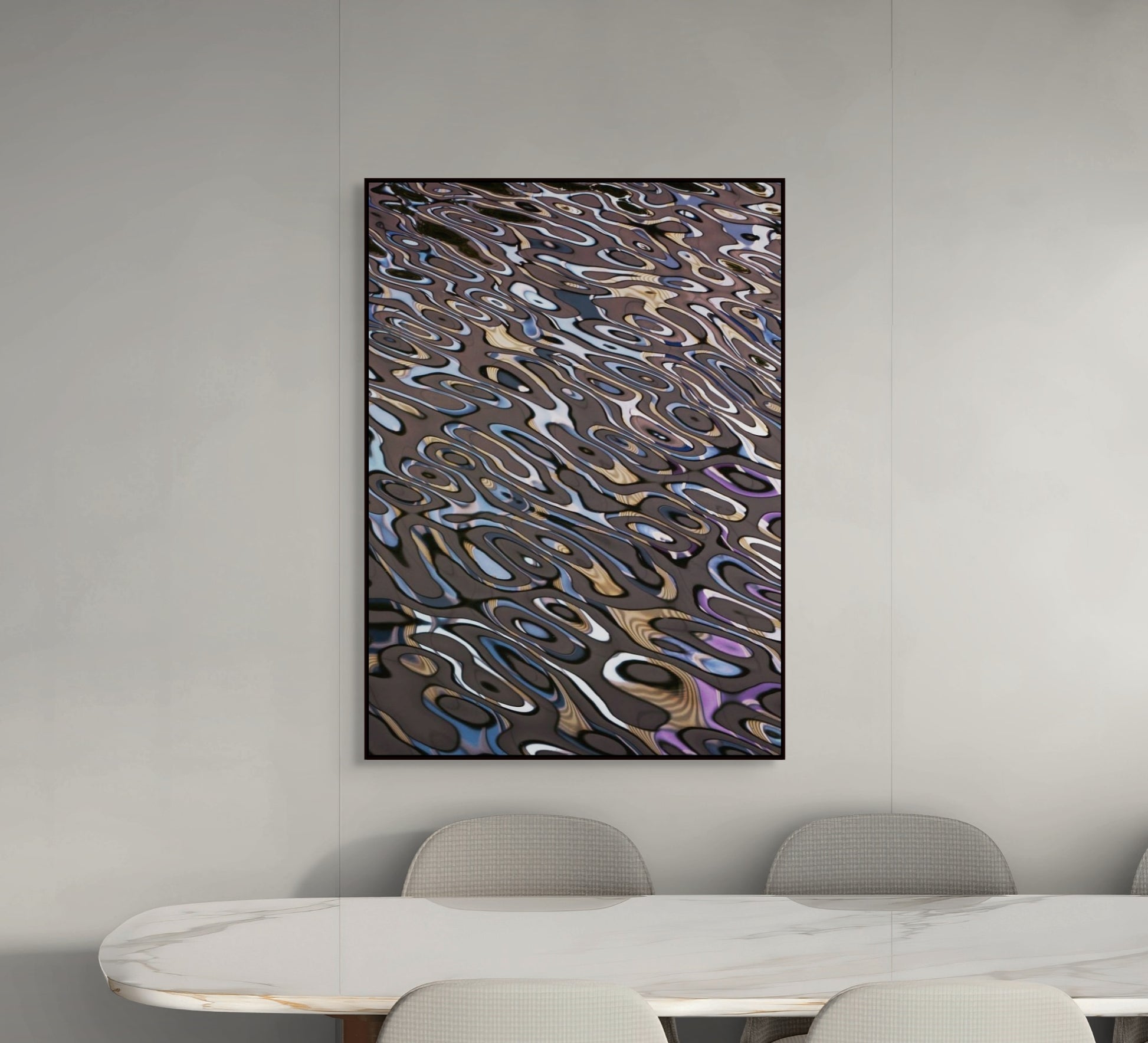 Abstract wall art in a modern room with a table and chairs.