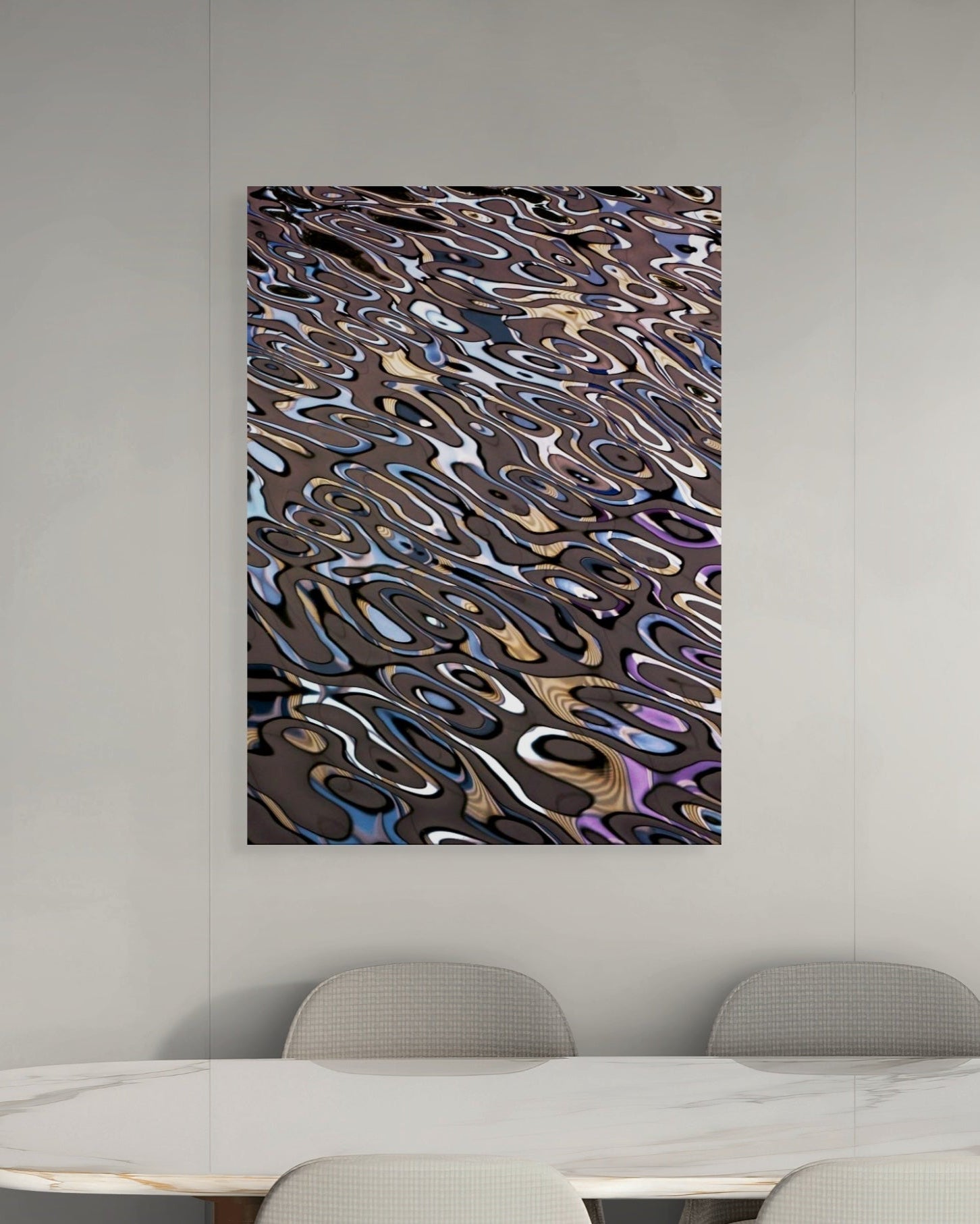 Abstract art piece on a wall above a dining table