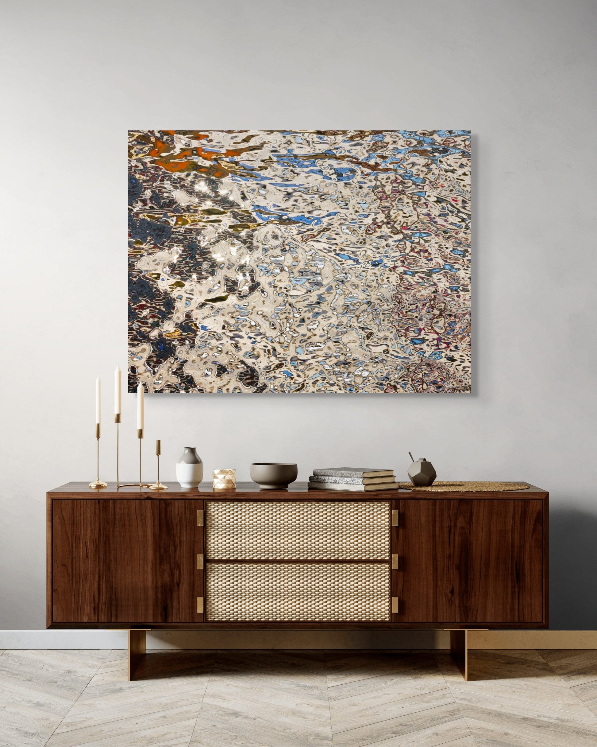 Echo Mitte by Johann Besse — abstract metal wall art above a modern walnut console with brass accents, styled with candles and ceramics in a neutral interior.
