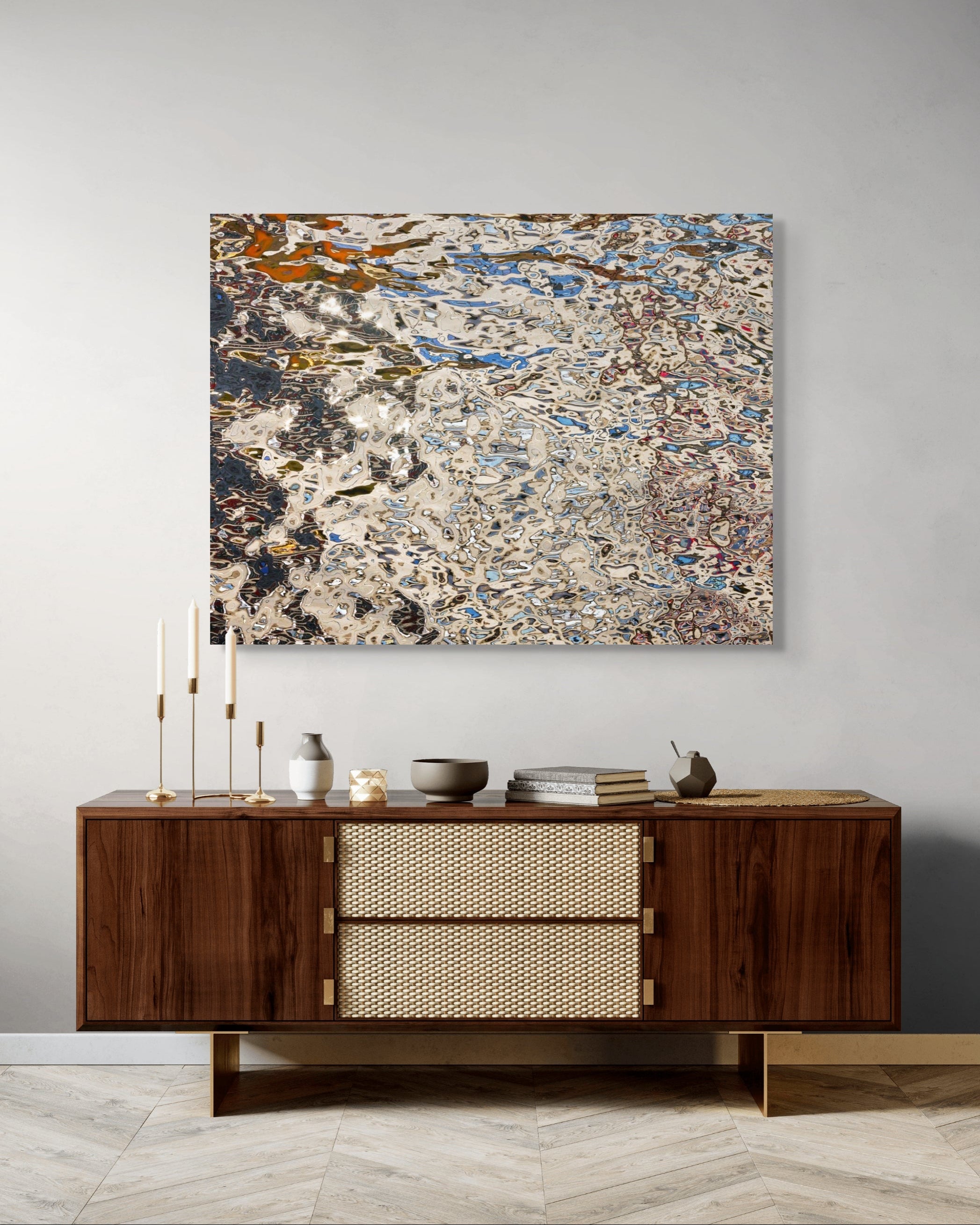 Echo Mitte by Johann Besse — abstract metal wall art above a modern walnut console with brass accents, styled with candles and ceramics in a neutral interior.