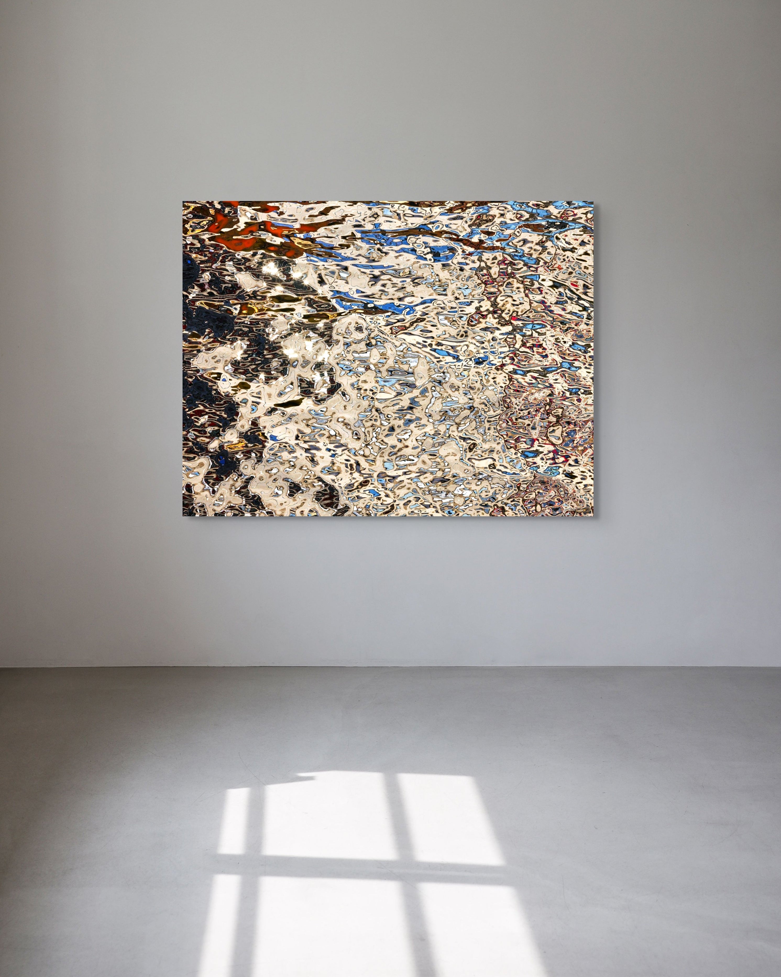 Abstract metal print on a gray wall with a light gray floor