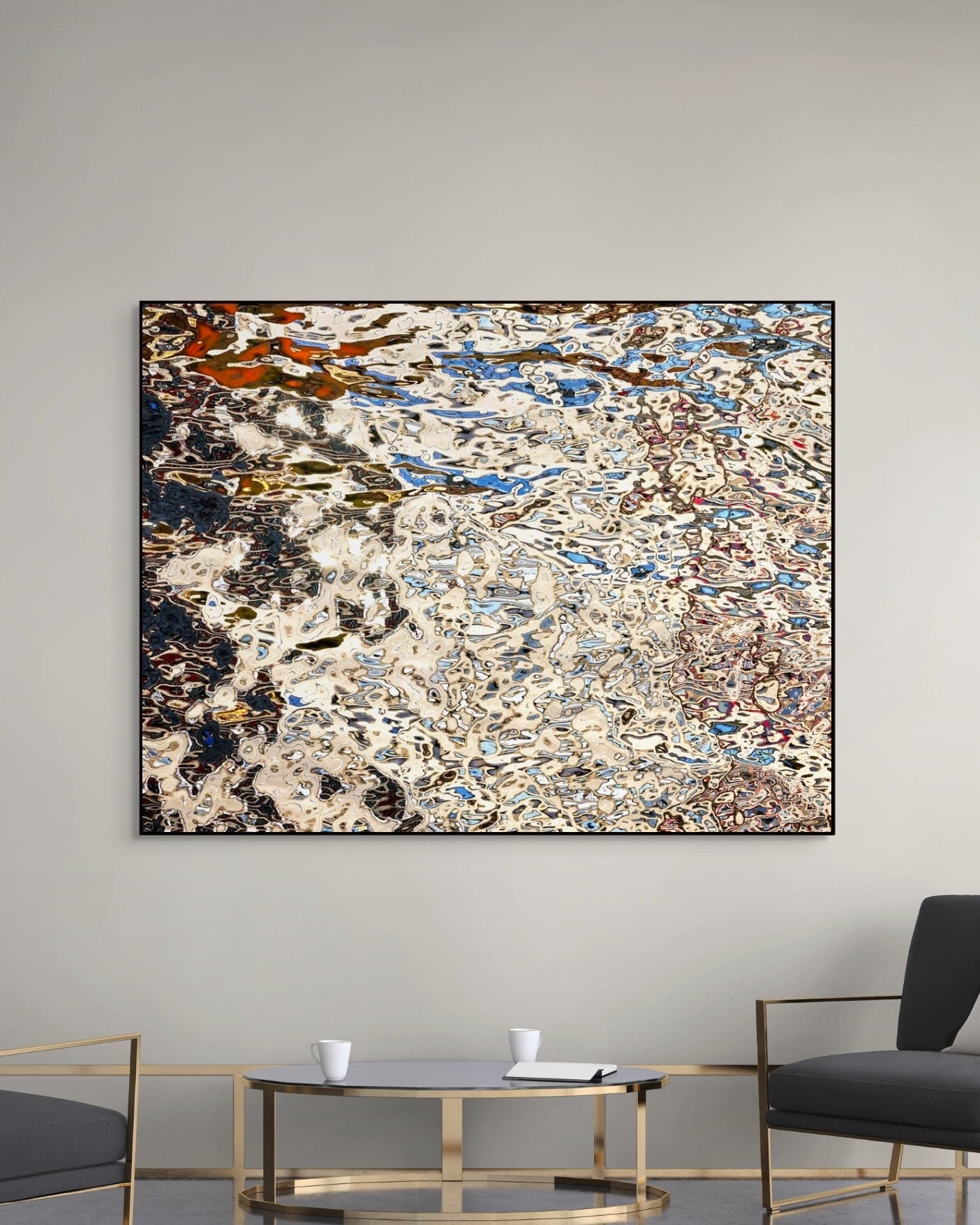 Abstract print on a wall above a modern living room setup with chairs and a table.