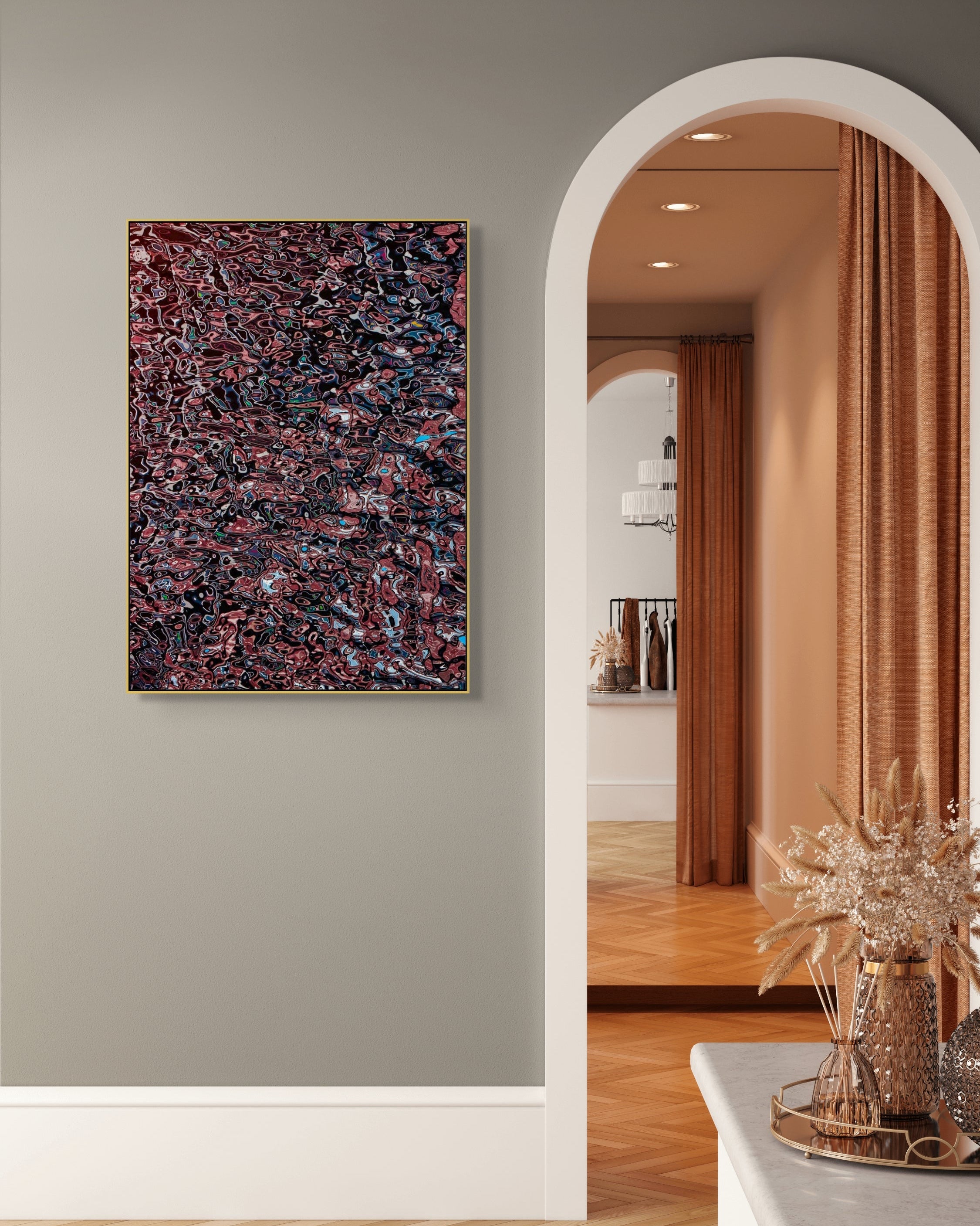 Large abstract photograph in a gold frame on a soft gray wall beside an arched doorway, combining red, black, and blue tones in a detailed, flowing pattern.