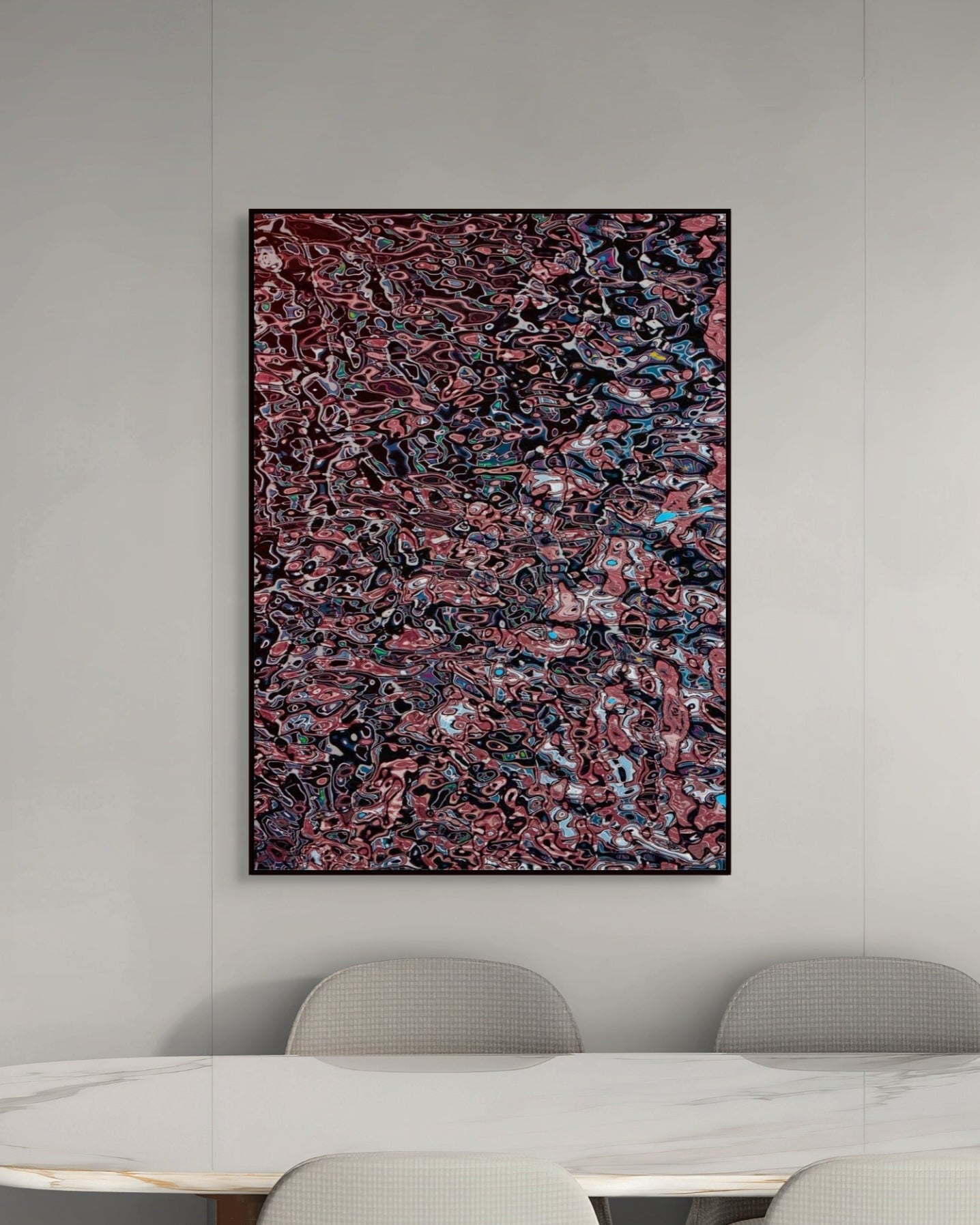 Abstract metal print on a wall above a dining table with chairs.