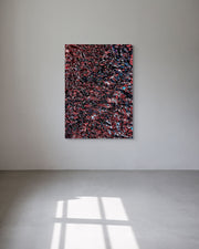 Abstract multicolored metal print on a white wall