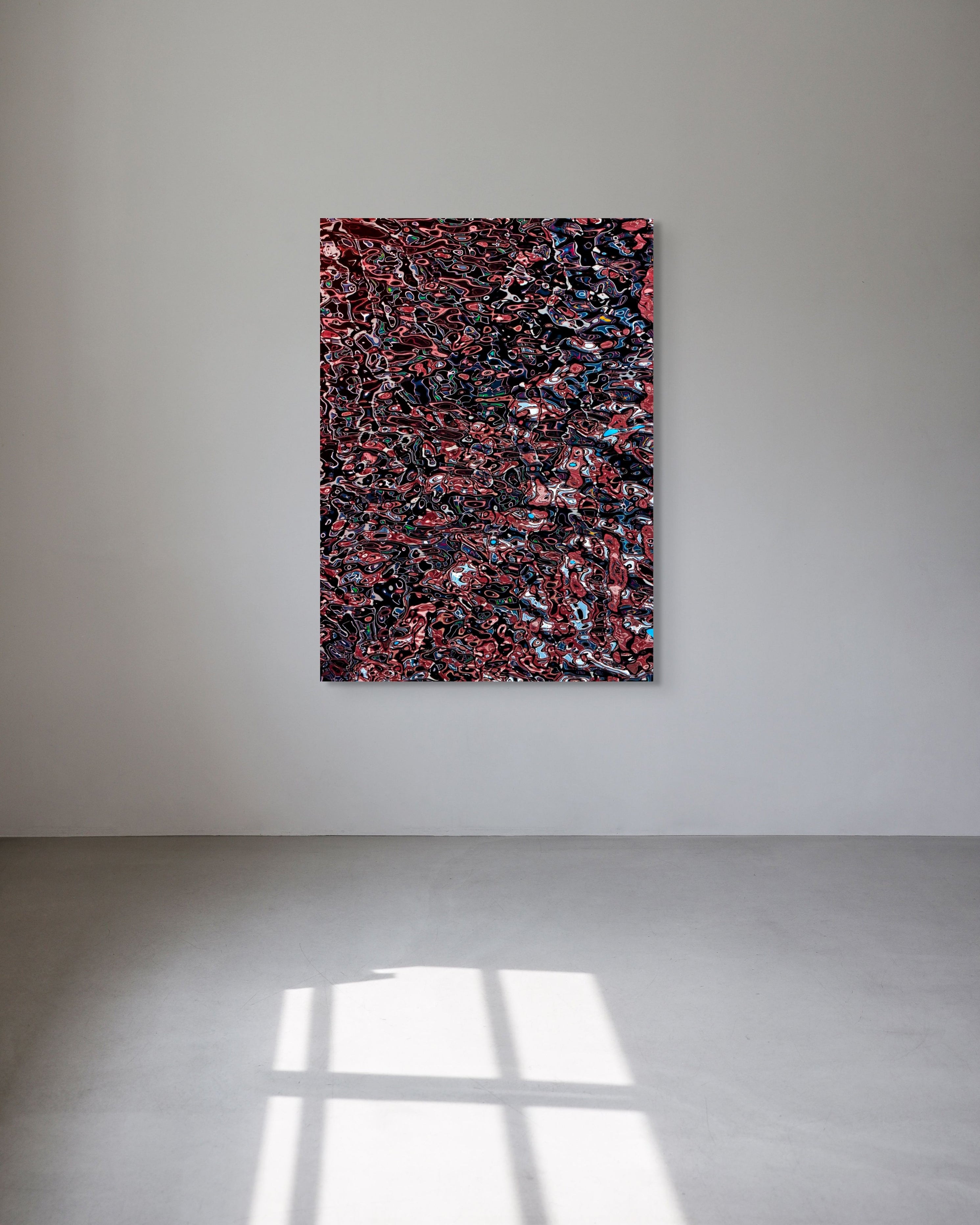 Abstract multicolored metal print on a white wall