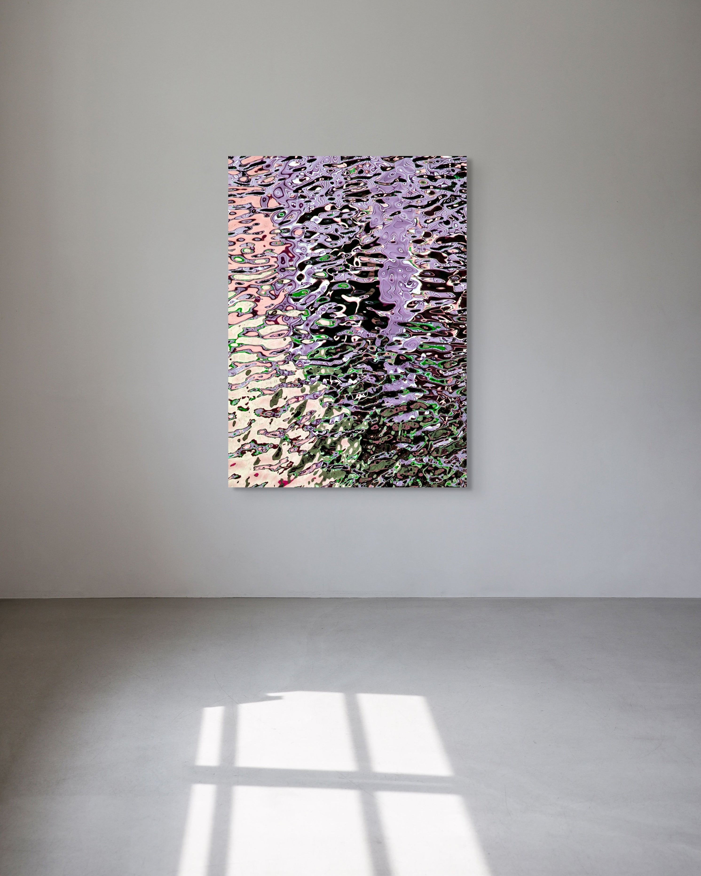 Abstract metal print on a white wall with a light source casting shadows.