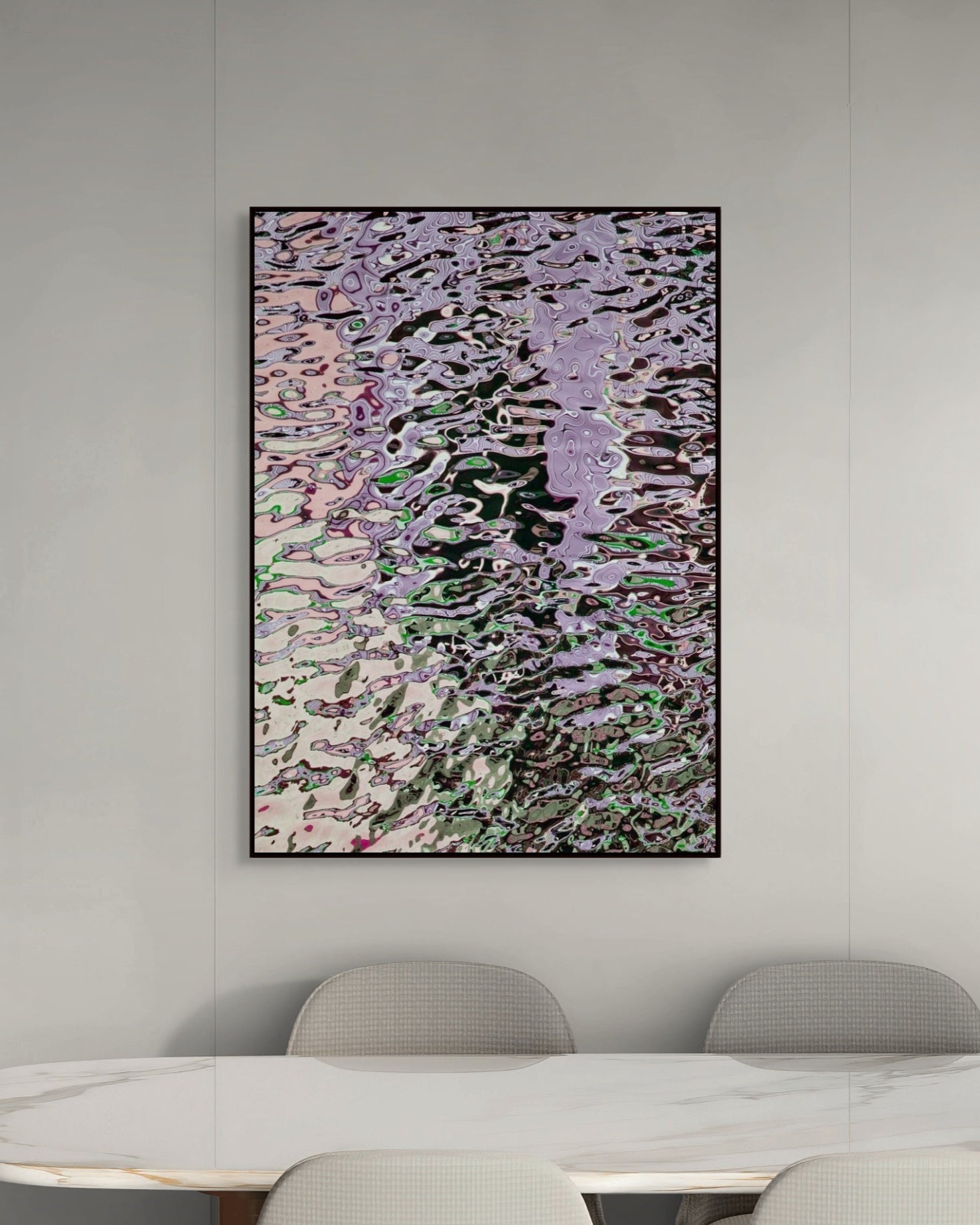 Abstract print on a wall above a dining table with chairs