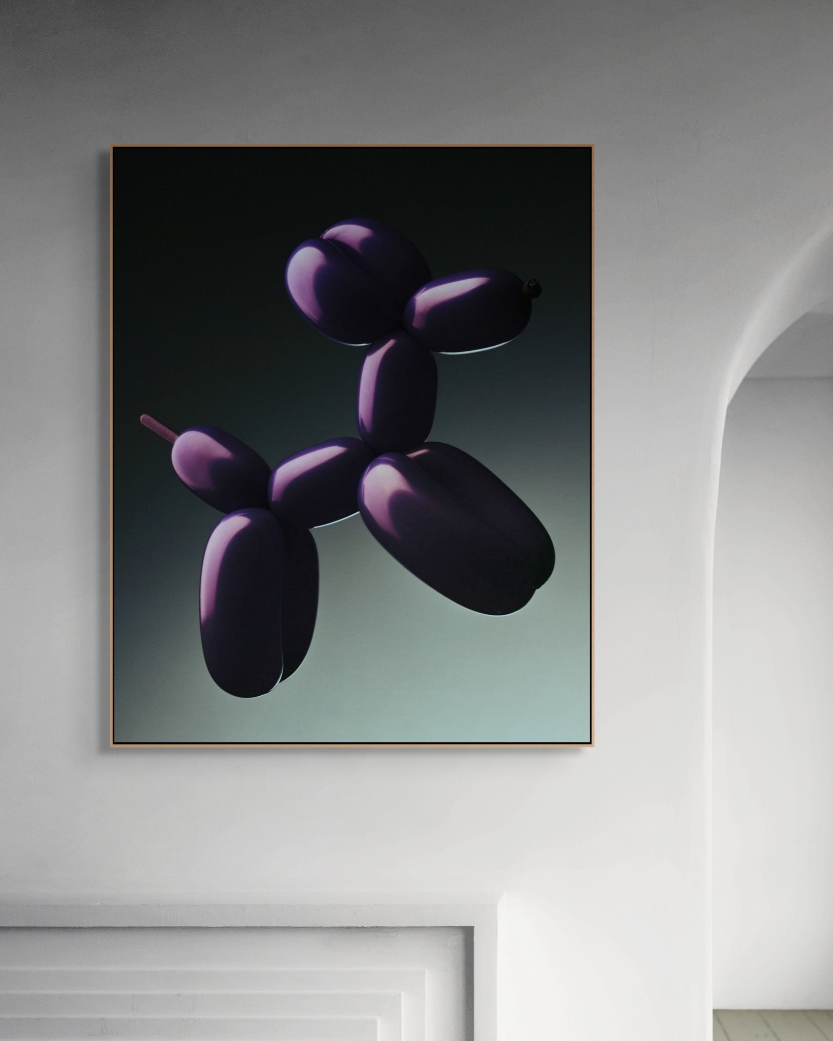 Framed artwork of a purple balloon dog sculpture on a wall.